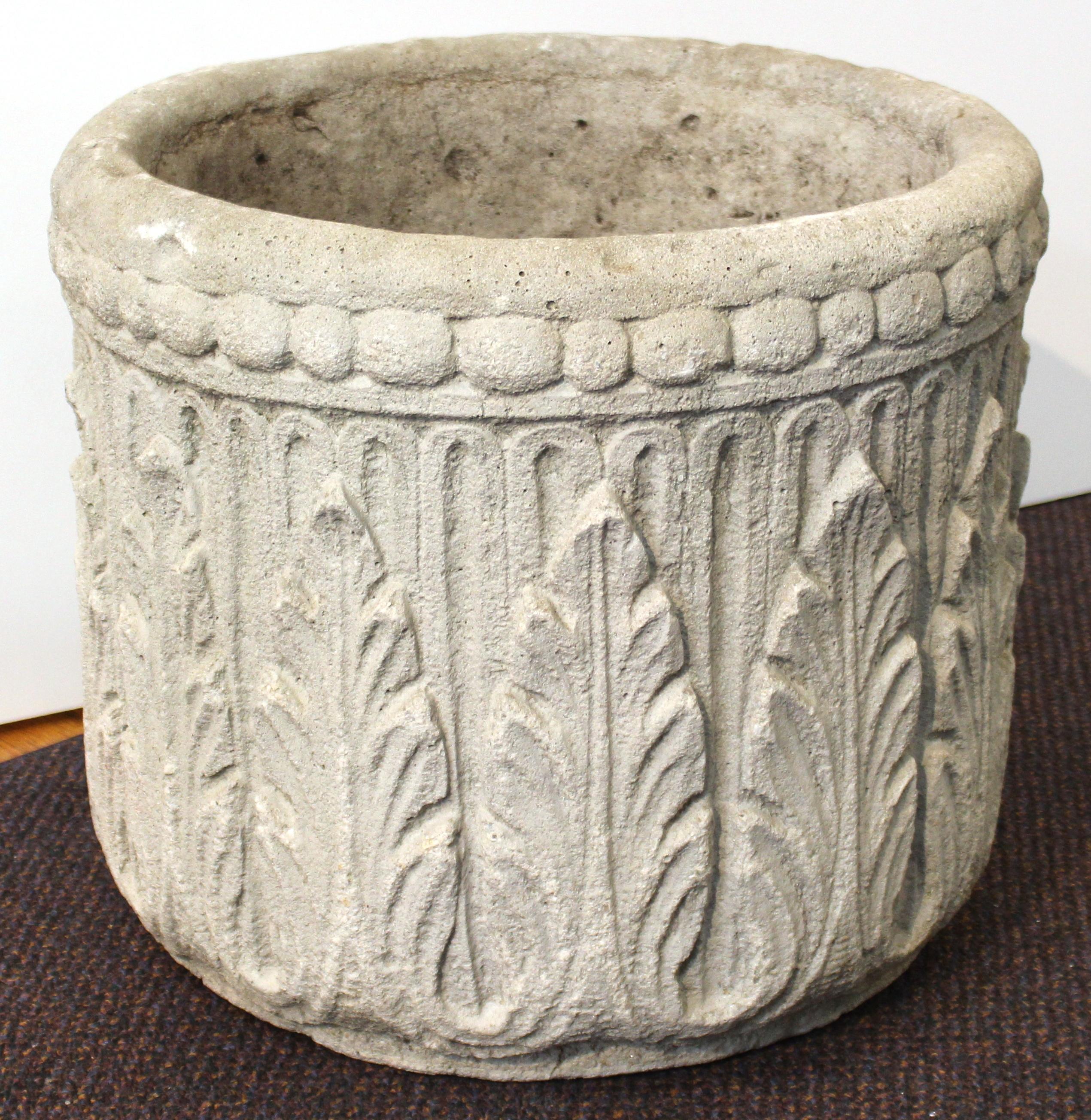 Set of four neoclassical Revival style garden planters made of concrete. The set consists of three larger planters with stylized acanthus leave decor and one smaller planter with a basket weave design. The set is in great vintage condition with