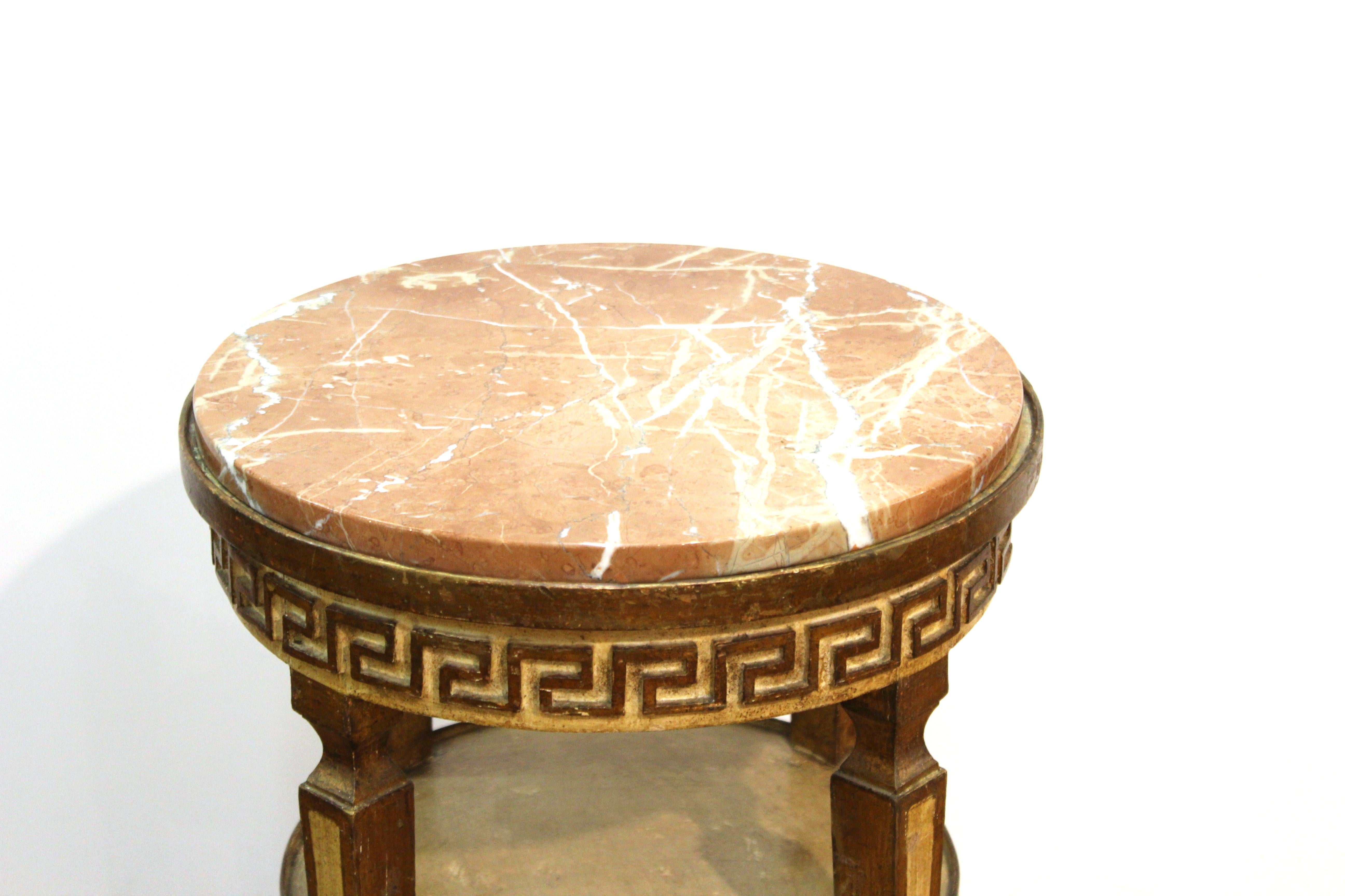 Hollywood Regency neoclassical Revival style side table in carved wood, with Grecian border and round brown veined marble top. In great vintage condition with age-appropriate wear.