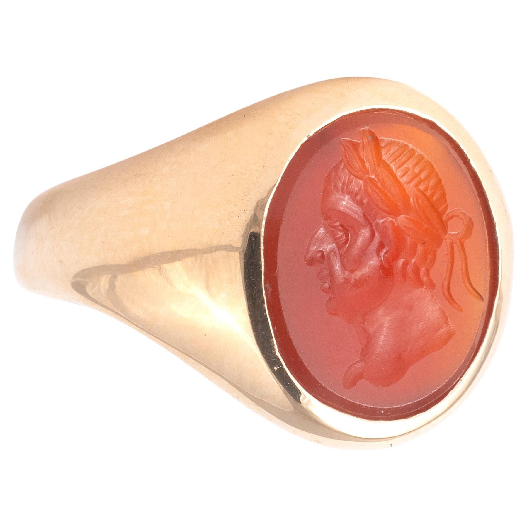 The open-set carnelian intaglio with beveled edge in gold shows in deep relief the carved-out image of Galba in profile turned to the side.
The carving depicts a man in profile facing to the viewer's right. The surface is carved with a wonderful