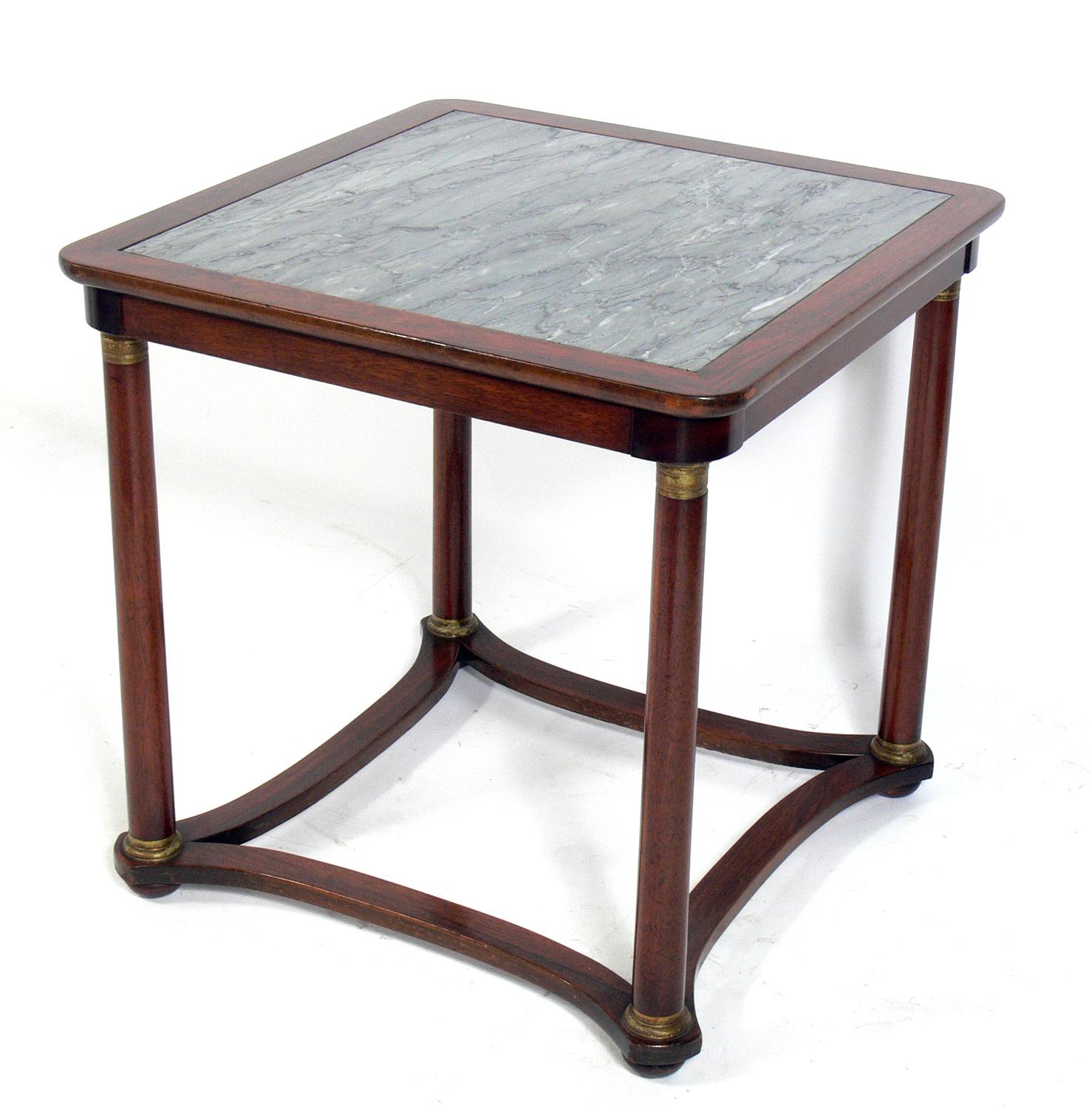 Neoclassical rosewood and marble table, probably French, circa 1940s, possibly earlier. It is constructed of rosewood and other woods with brass or bronze mounts and an Italian gray marble-top with beautiful veining.