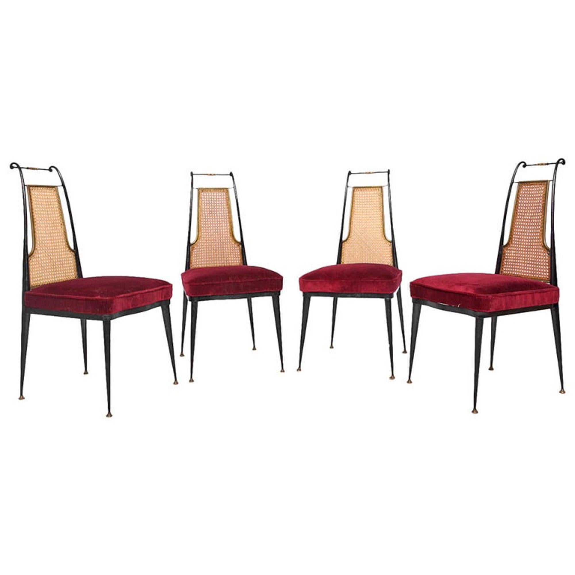 Mexico 1950s: by Mexican Modernist Arturo Pani custom set of our Neoclassical Regency dining chairs in ruby red velvet with brass capped legs.
Chairs feature black painted scrolled iron, woven cane lattice back, brass accents and original red velvet