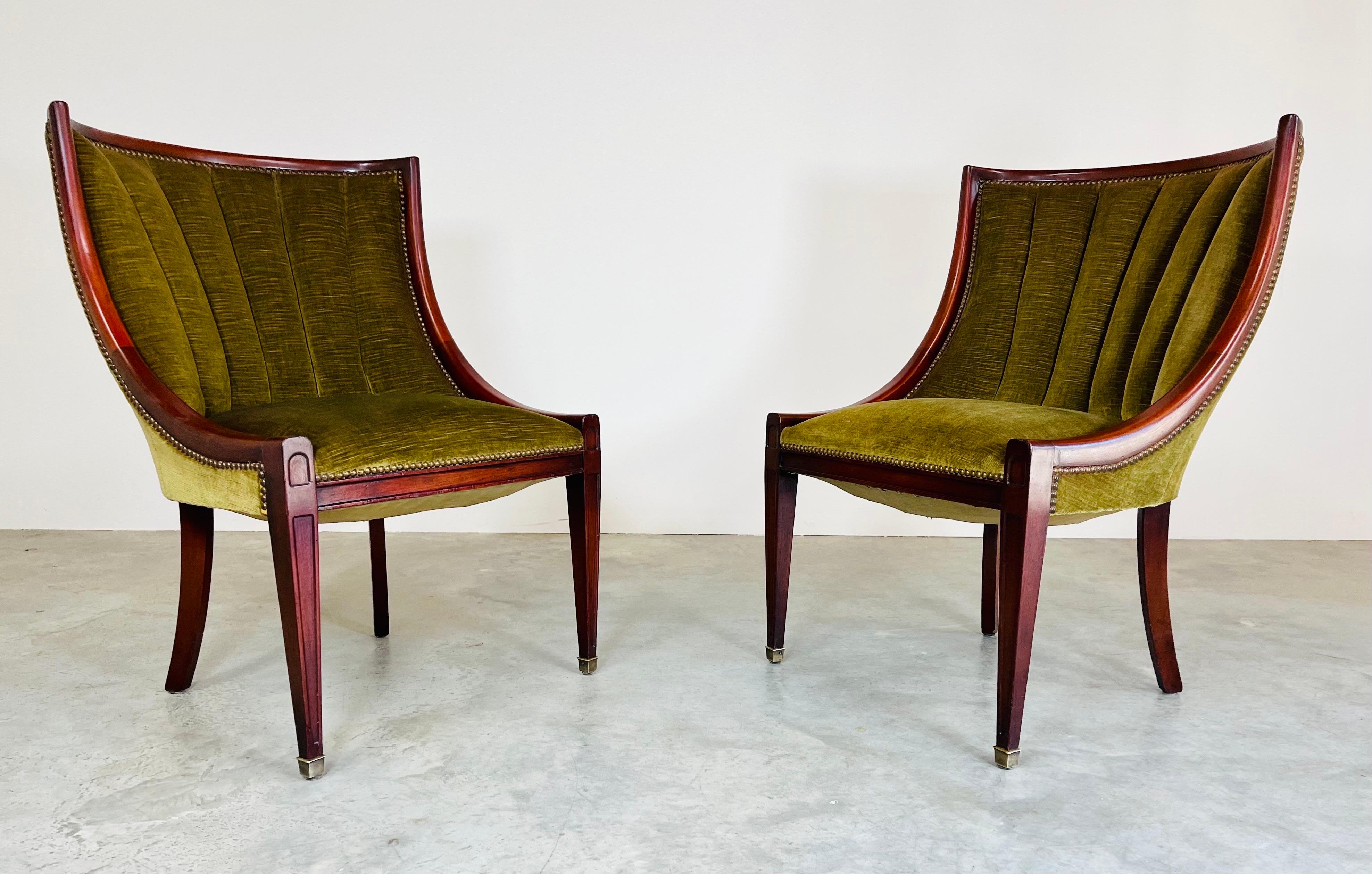 A pair of mahogany swag arm channel back velvet slipper chairs with Klismos or saber back legs and brass sabots on the front attributed to Sally Sirkin Lewis. Absolutely stunning and in very good vintage condition. The mahogany has been carefully