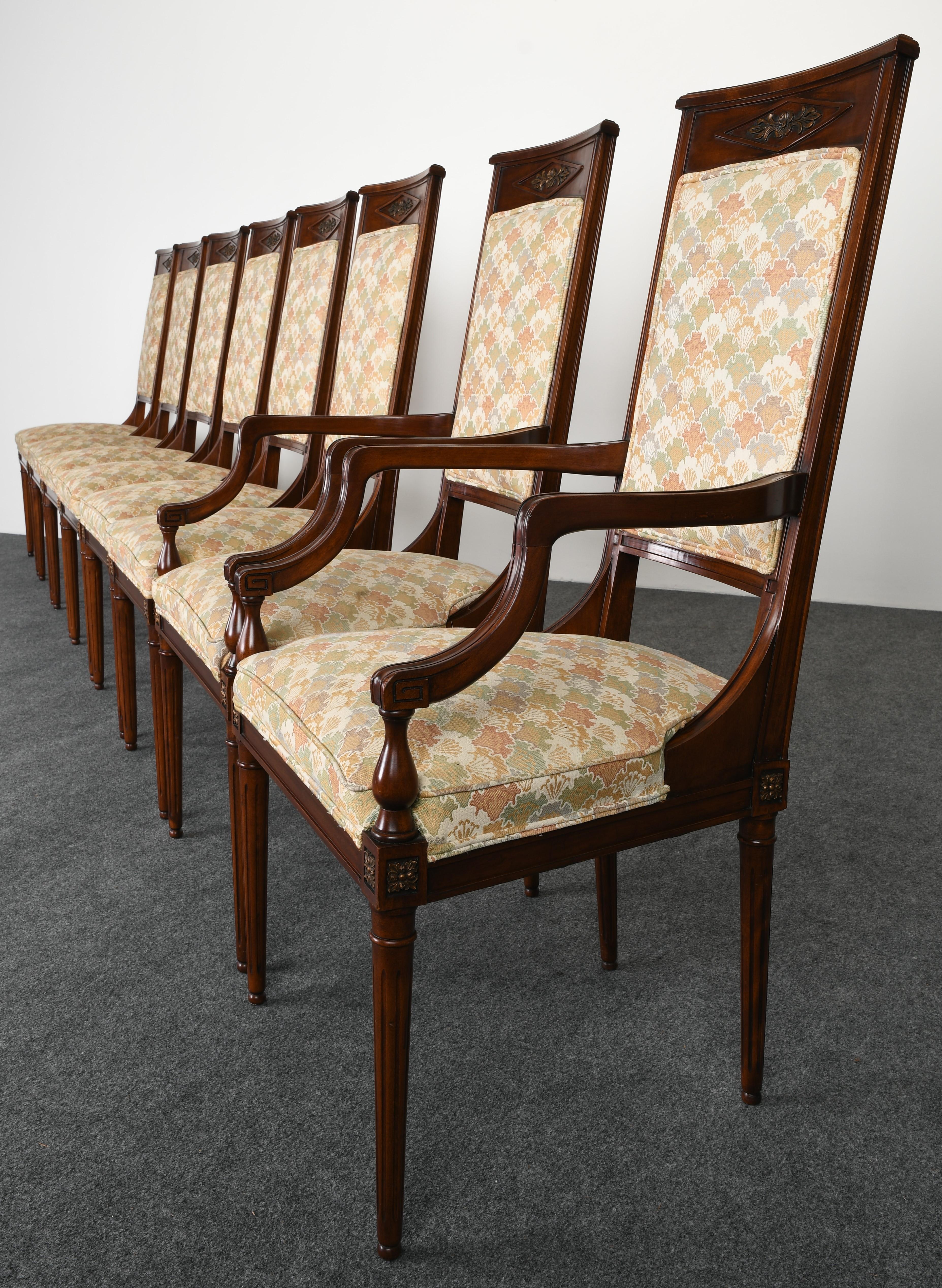 An elegant neoclassical style set of eight mahogany dining chairs in the style of Karges Furniture Company. Very good vintage condition with age appropriate wear. One ball foot has chip not noticeable, as shown in images. Hand carved crest flower