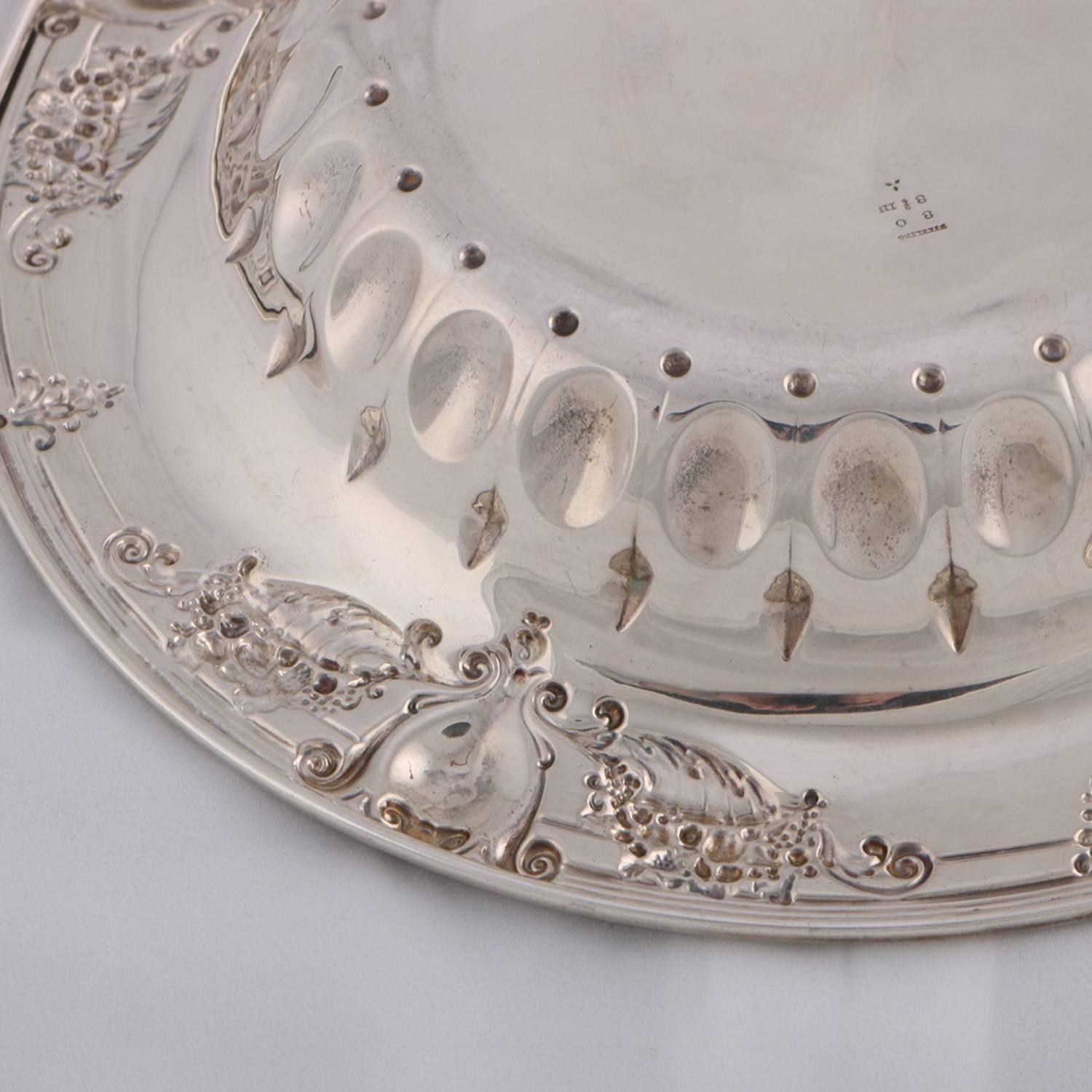 neoclassical round sterling silver bowl features rim with shield, cornucopia and floral Repousse with further high relief interior decoration, marked Sterling on base, 6.3 toz, 1900.

***DELIVERY NOTICE – Due to COVID-19 we are employing NO-CONTACT