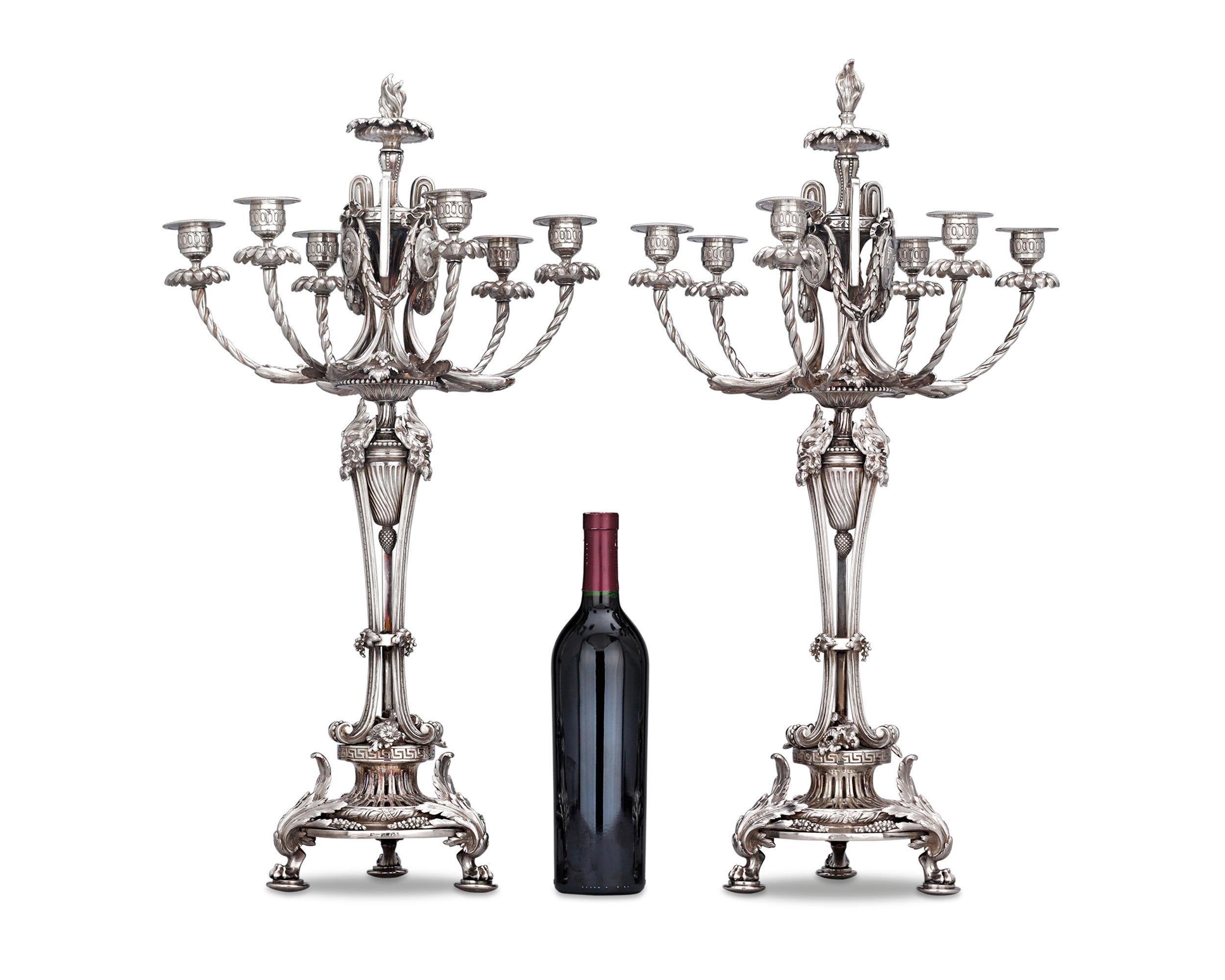This extraordinary pair of silver plate six-light candelabra was crafted by the celebrated luxury silver manufacturers Christofle. Executed in the neoclassical style, these candelabra exemplify the firm's unfailing eye for timeless design and