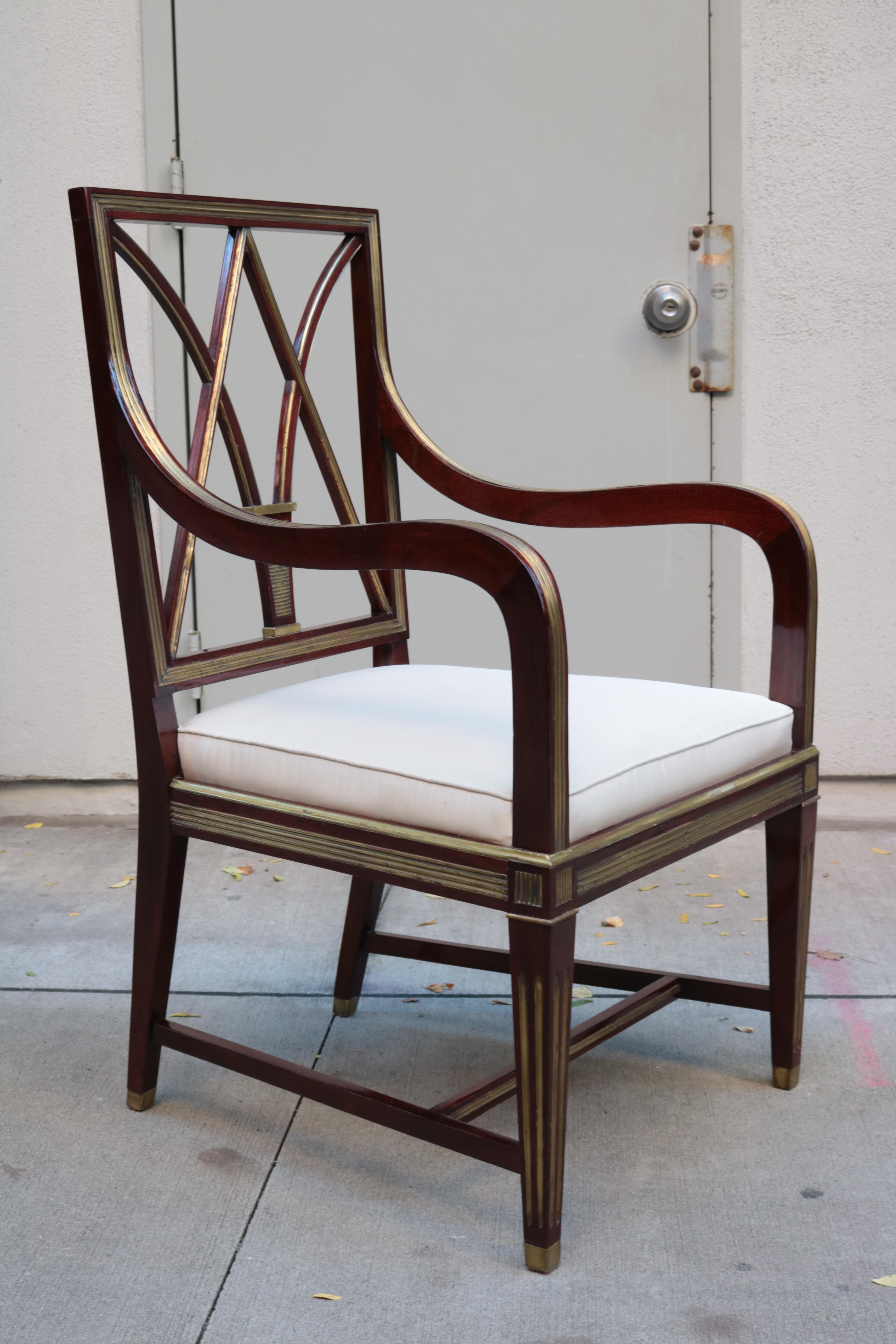A fine neoclassical armchair.
Mahogany with patinated brass inlay, details and sabots.