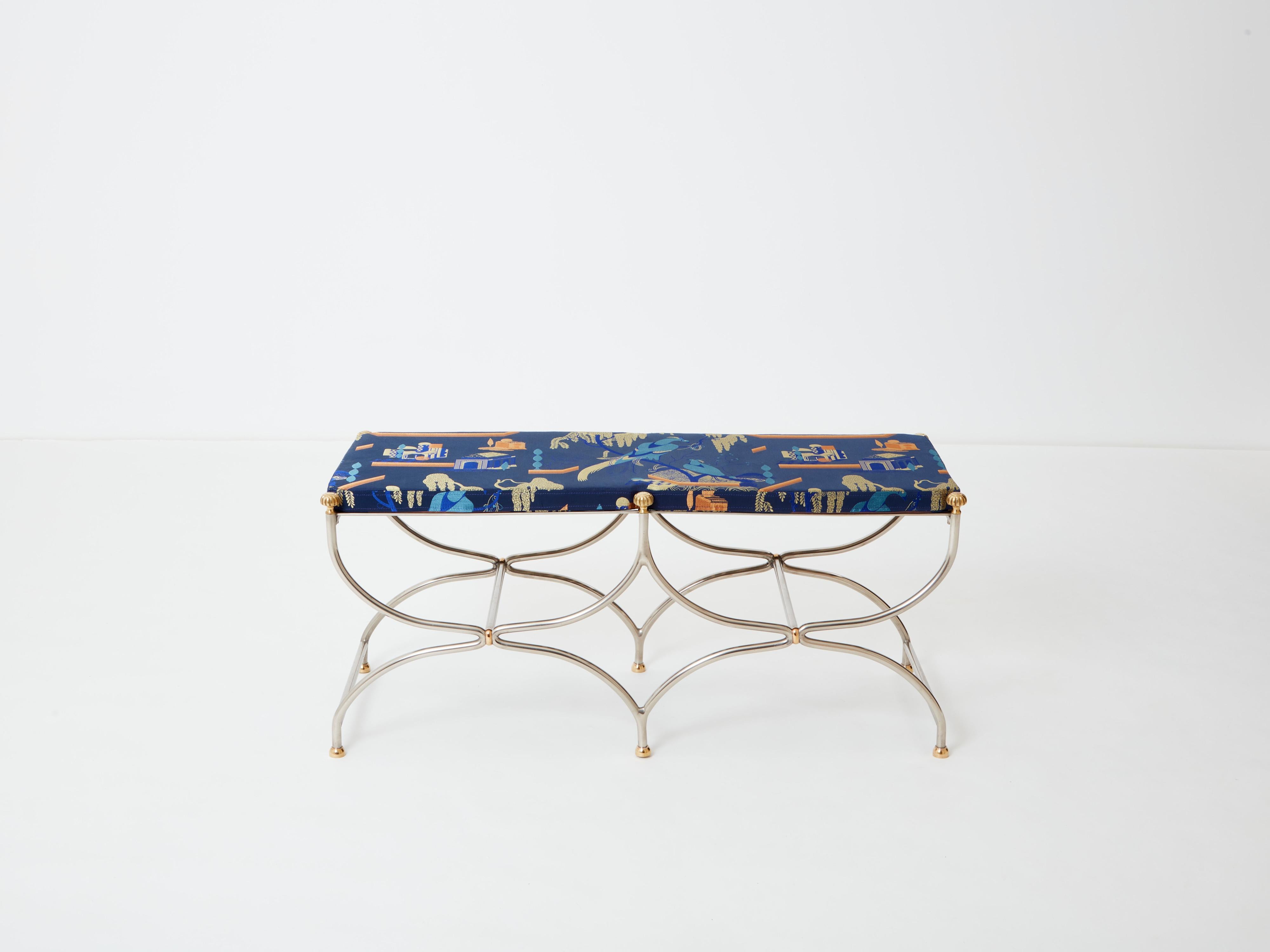 Beautiful 1960’s Curule Savonarola bench made of heavy stainless steel metal with brass accents. This timeless bench was created by French interior design firm Maison Jansen in the early sixties. The sparse original structure feels like a piece of