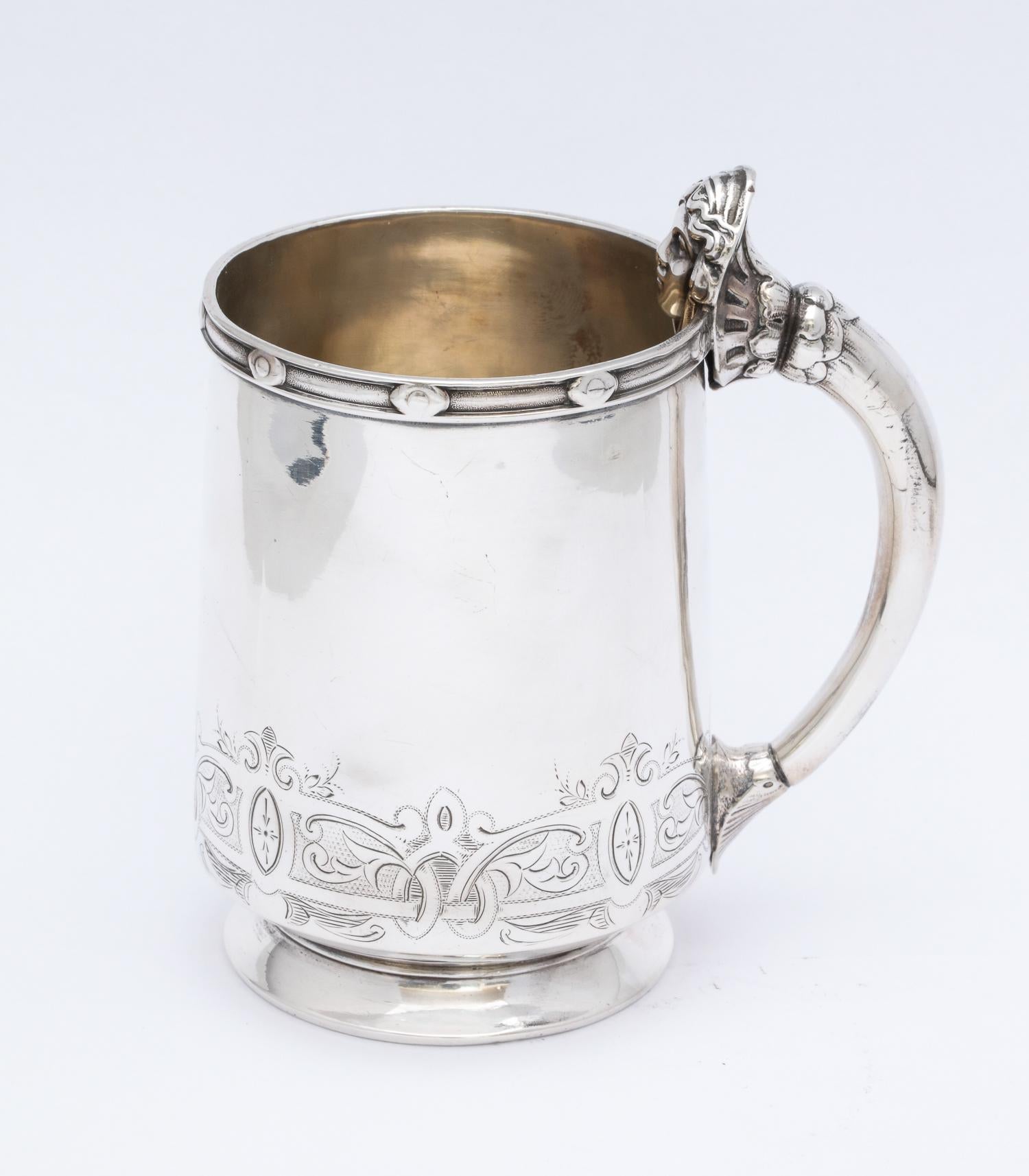 Neoclassical, sterling silver child's mug/cup, Gorham Mfg. Co, Providence, Rhode Island, circa 1860. Handle is decorated with a neoclassical woman's head. Interior is lightly gilded. Decorative border along top edge; etched work along bottom of cup.