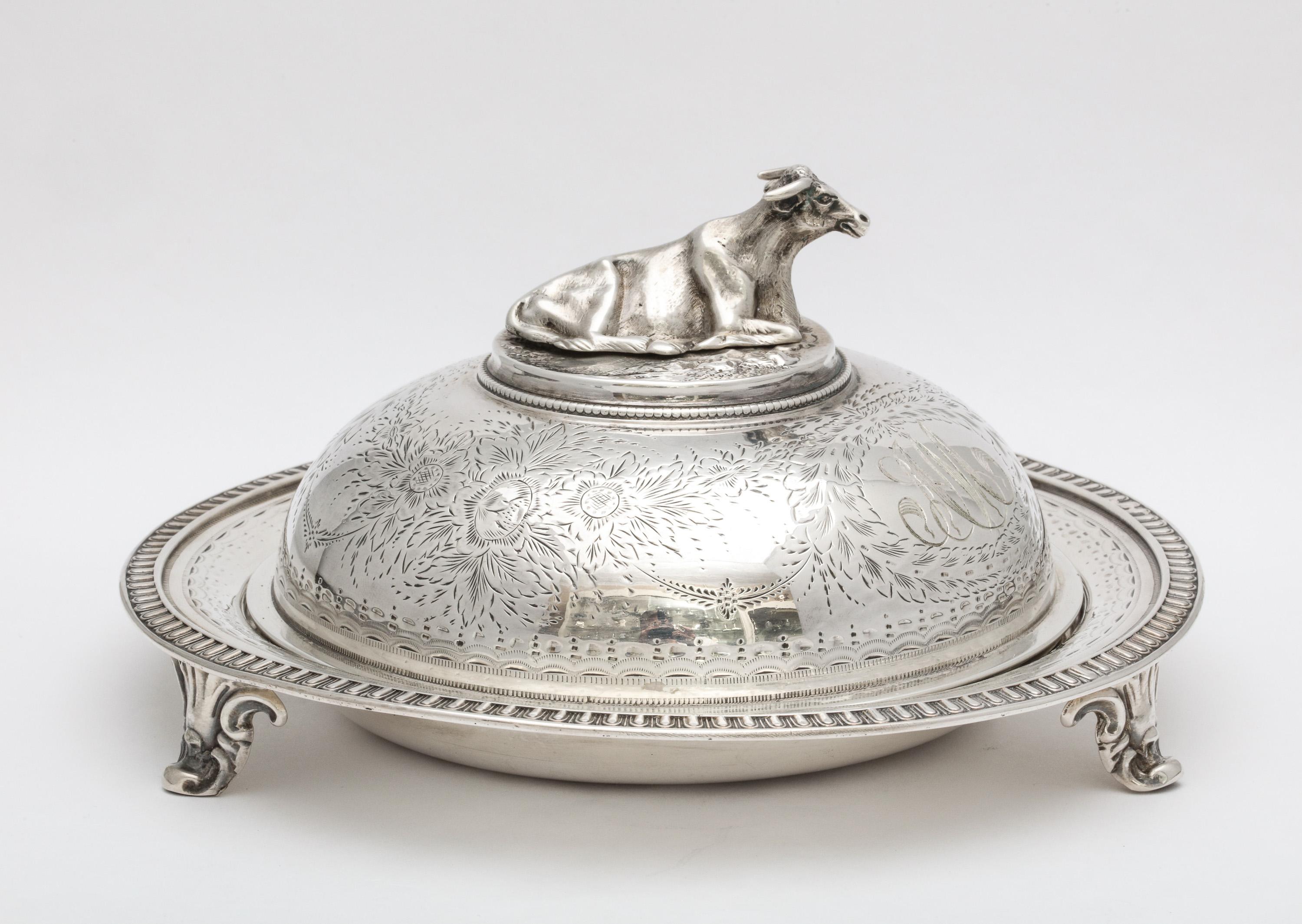Neoclassical, sterling silver, covered, footed butter dish with removable, pierced insert, New York, year hallmarked for 1859, Gale & Willis - makers. Lid has a cow finial. Measures 4 1/4 inches high x 7 inches diameter. Total weight is 12.795 troy