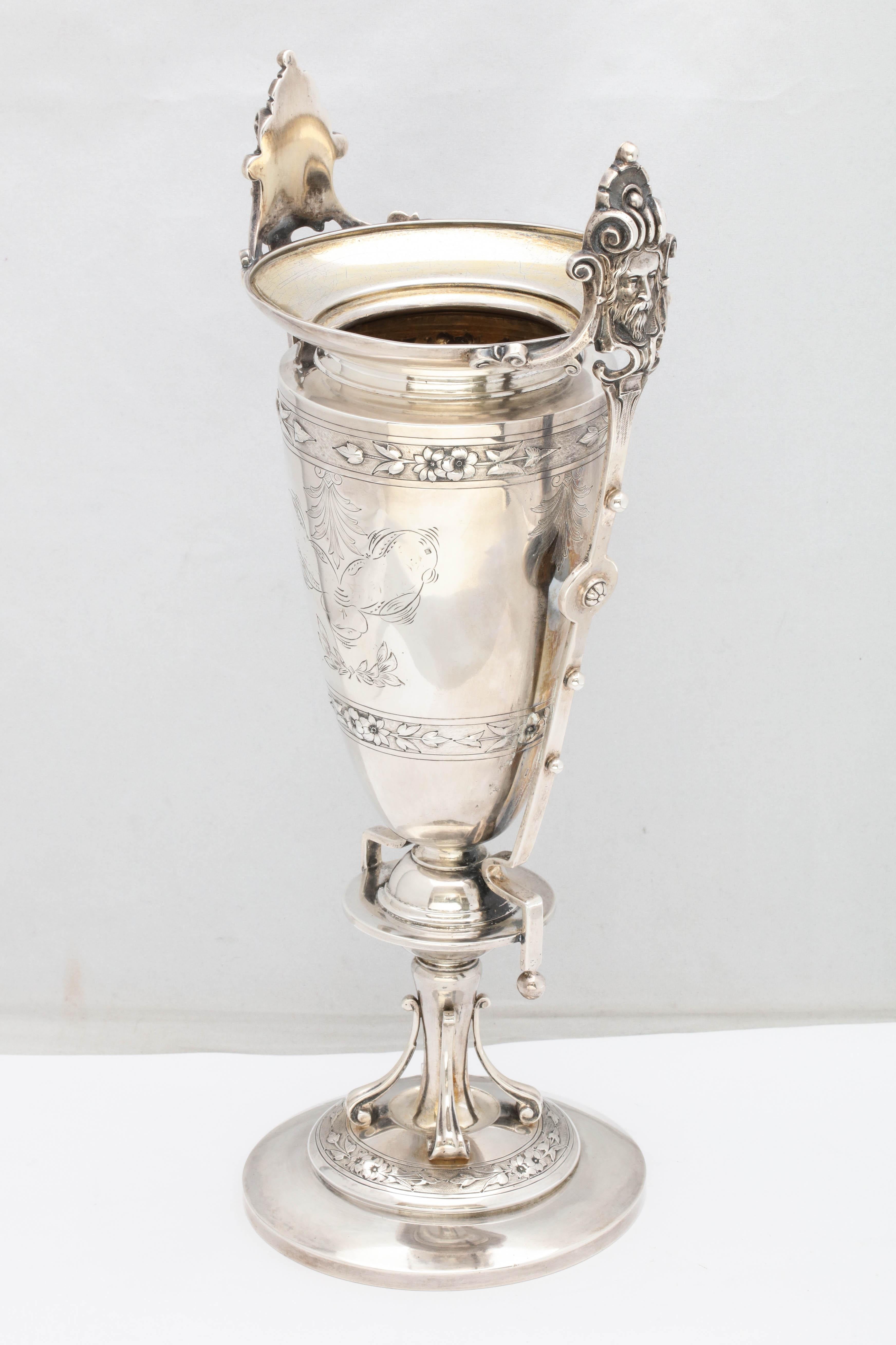 Neoclassical, sterling silver vase, Boston, Mass., circa 1870, Shreve, Stanwood and Co. - makers. Handles are topped by bearded masks. Some etched work. Stepped up circular base. Measures: 13 1/2 inches high x over 4 3/4 inches diameter of base x 4