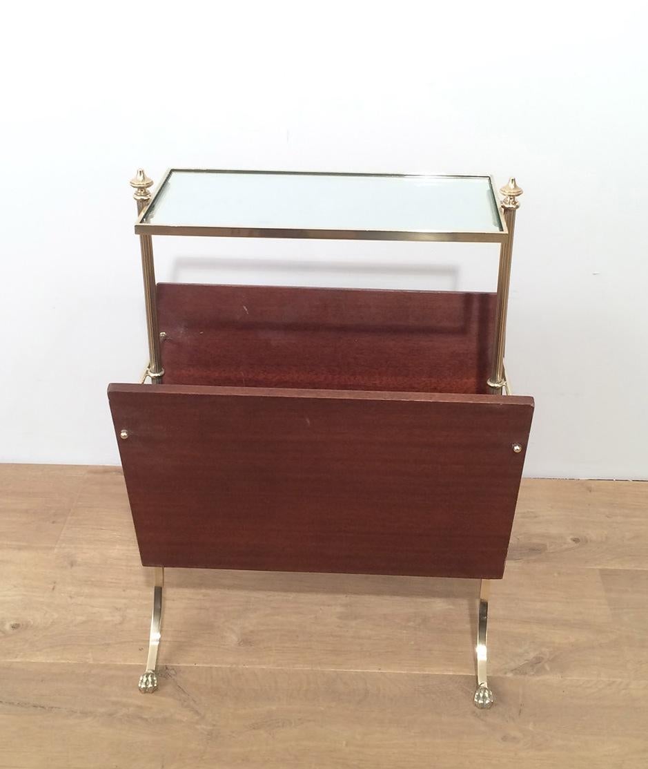 This nice neoclassical style magazine rack is made of mahogany and brass with claw feet. This is a French work by Maison Jansen, circa 1940.