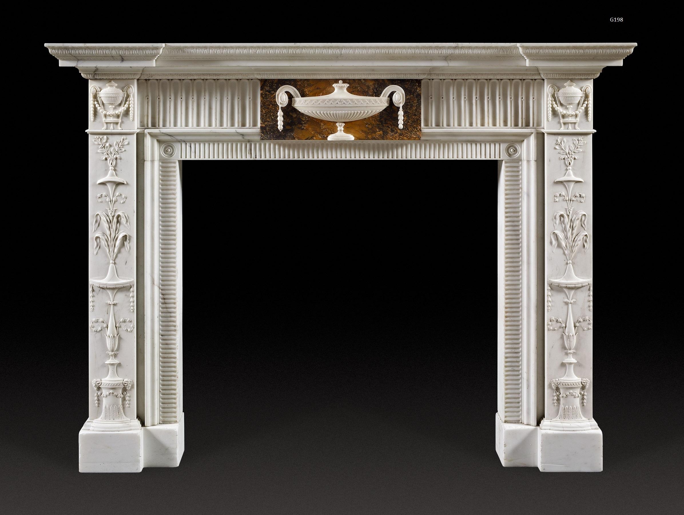 The breakfront, moulded shelf above the frieze which is centred with a tablet carved with tazza shaped, lidded urn in statuary on sienna marble. This is flanked by bands of flutes; the blockings above the pilaster, arabesque decorated jambs with