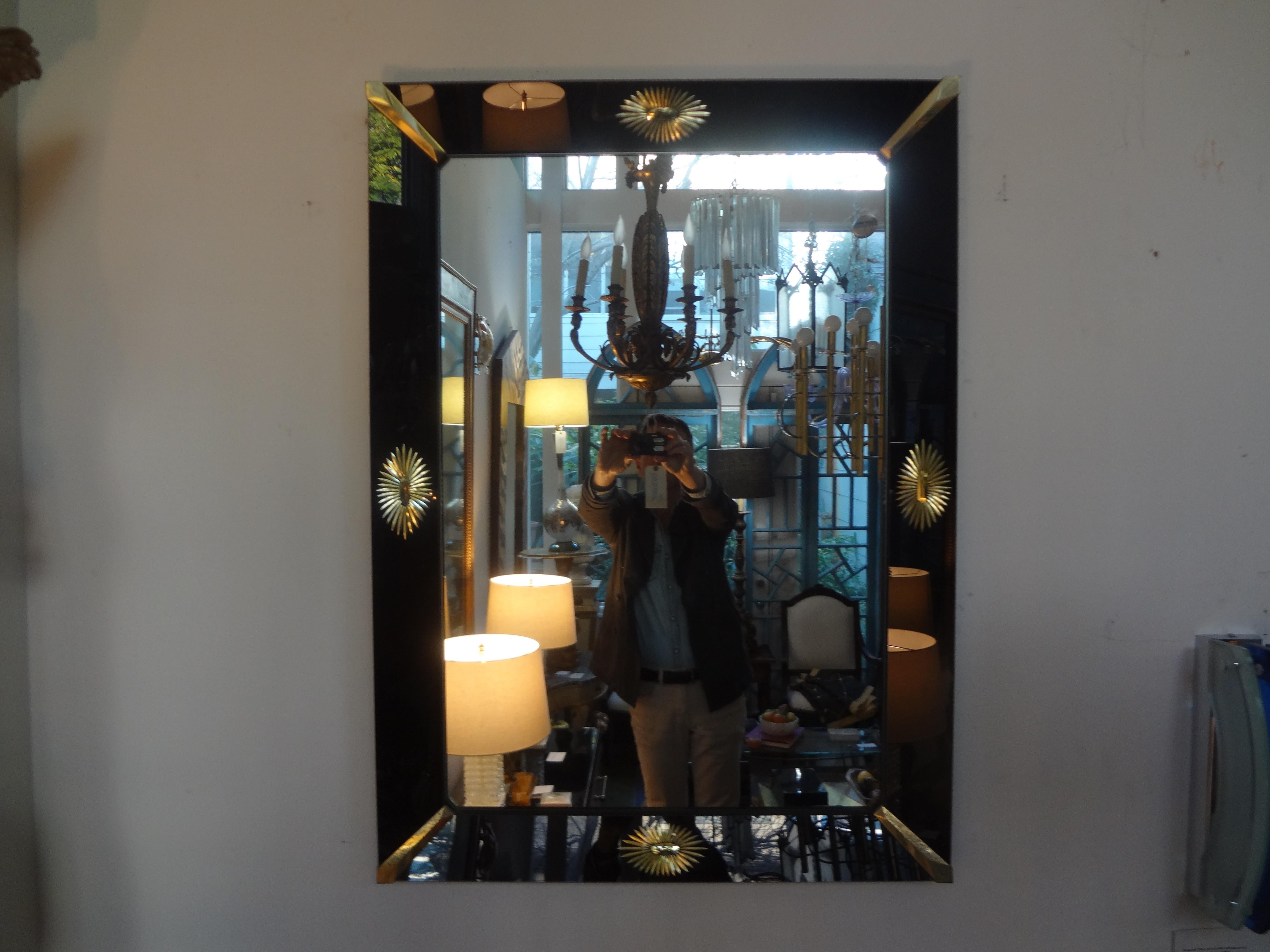 Stunning mid-century neoclassical style rectangular Venetian mirror with a black mirrored perimeter, brass corners and a central gilt star on each side.
This beautiful mirror can be displayed in either direction. We have a slightly larger