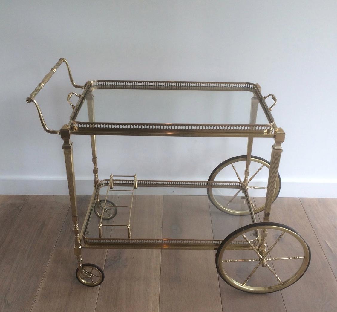 This nice neoclassical style bar cart is made of brass. Both trays are removable. This is a French work by Maison Jansen. Circa 1940
