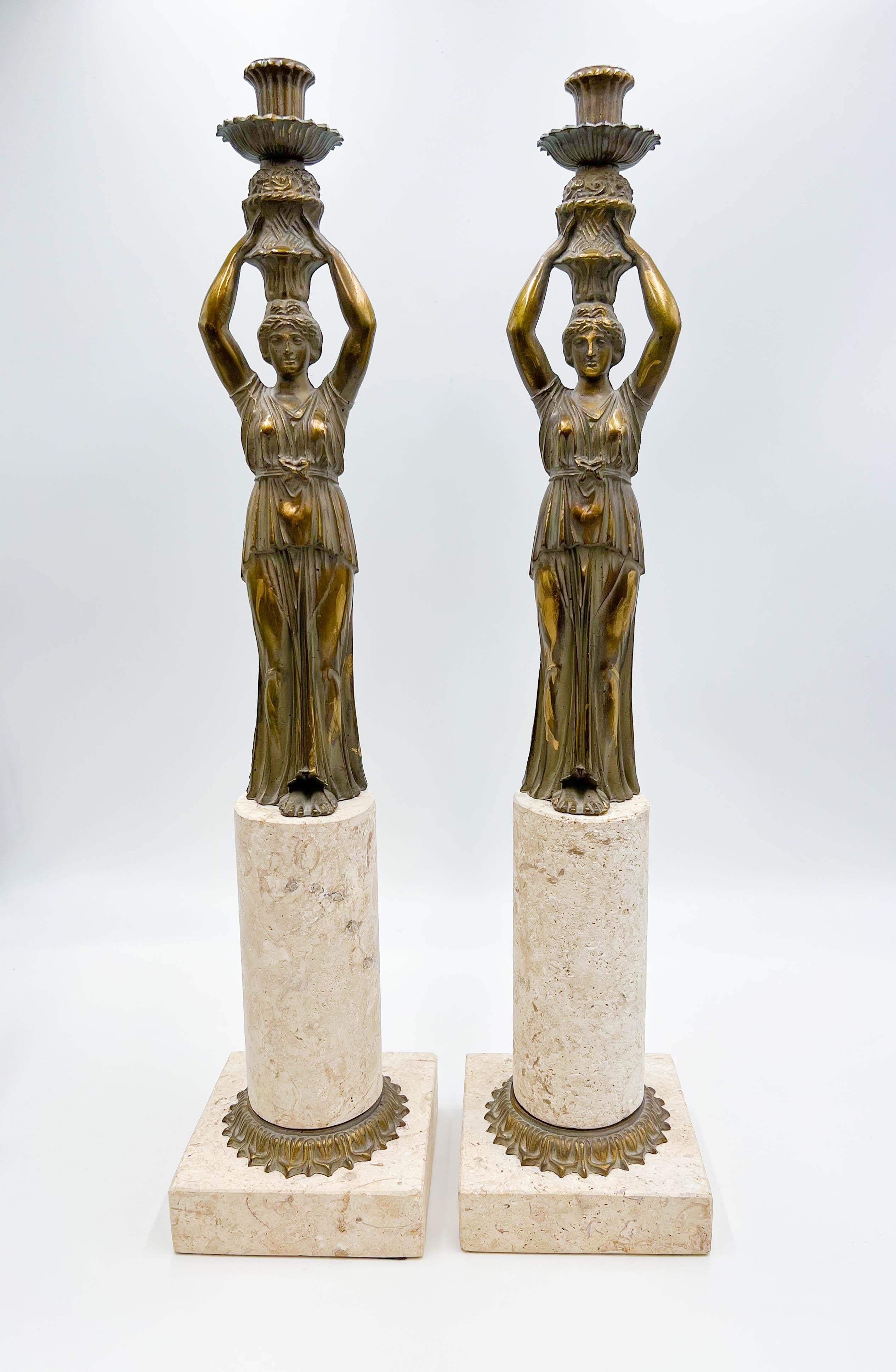Introducing a pair of solid brass and limestone candleholders., characteristic of the Neoclassical and Art Nouveau styles. The figural candleholders are mounted on a limestone base, creating a visually striking combination of materials.

Condition:
