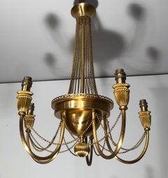 Neoclassical style brass chandelier decorated with pearl garlands. French work.