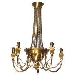 Neoclassical style brass chandelier decorated with pearl garlands. French work.