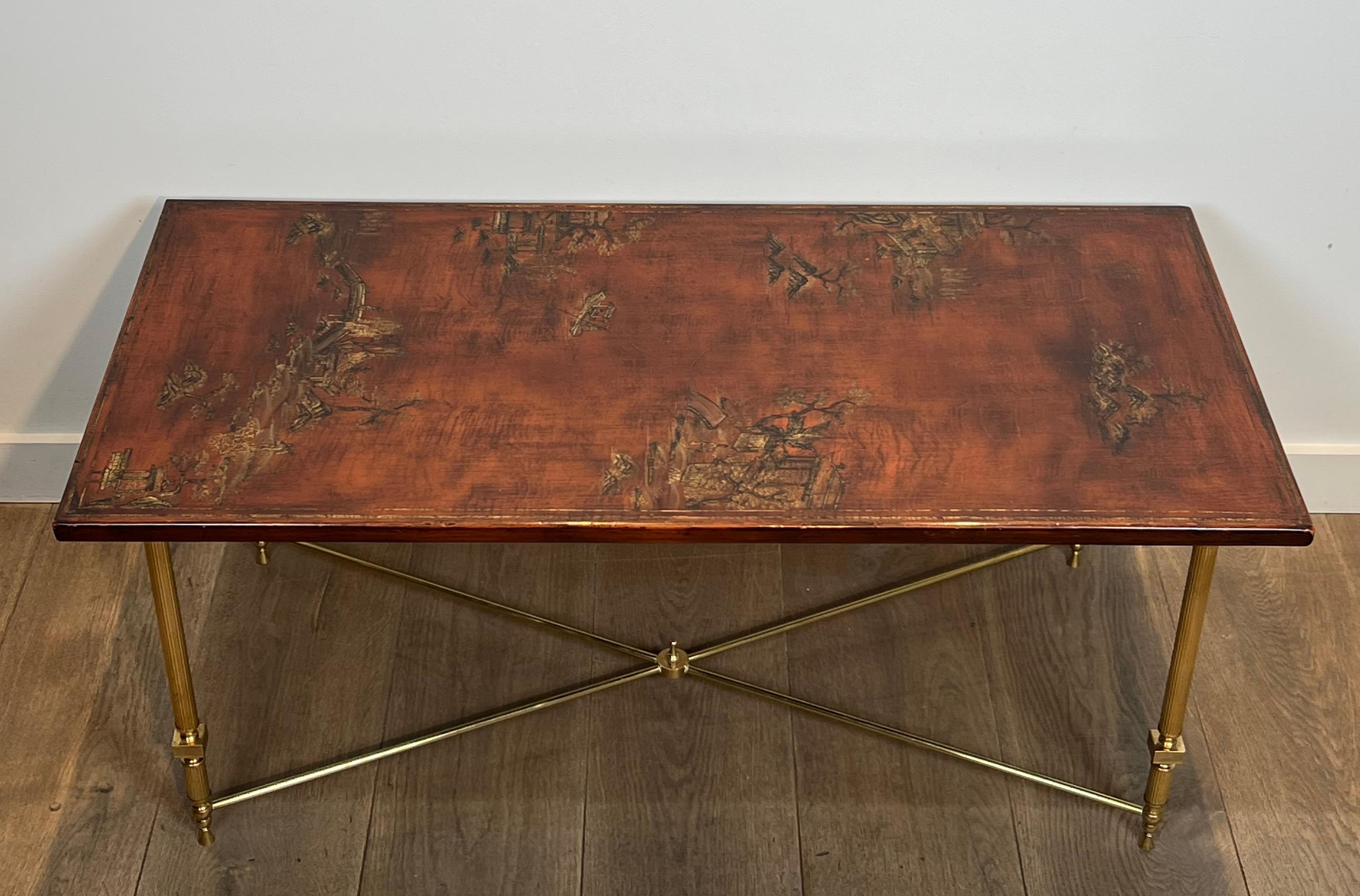 This neoclassical style coffee table is made of brass with wooden lacquered top representing Chinese scenes. This is a French work attributed to Maison Jansen. Circa 1940