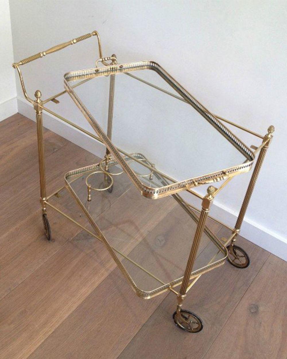 This neoclassical style bar cart is ade of brass with 2 removable Trays. This is a French work by famous Maison Jansen. Circa 1940.
 