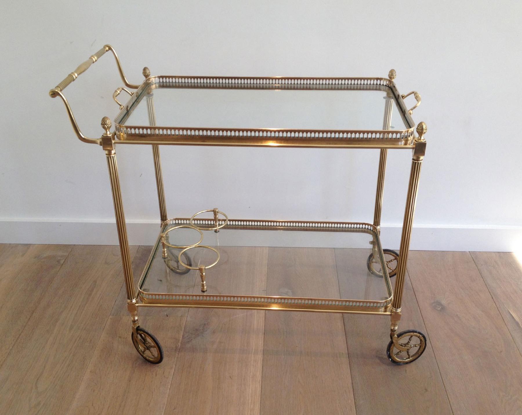 This nice and elegant neoclassical style drinks trolley is made of brass with removable glass trays. This is a French work by Maison Jansen. Circa 1940