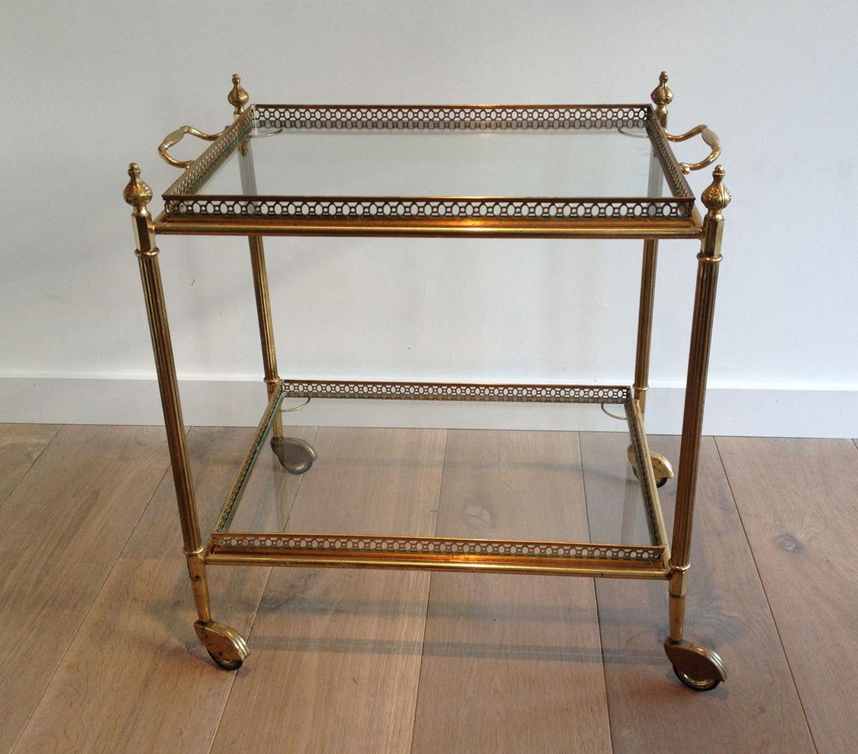 This neoclassical style drinks trolley is made of brass with removable trays. This bar cart is a French work in the style of Maison Jansen. Circa 1940