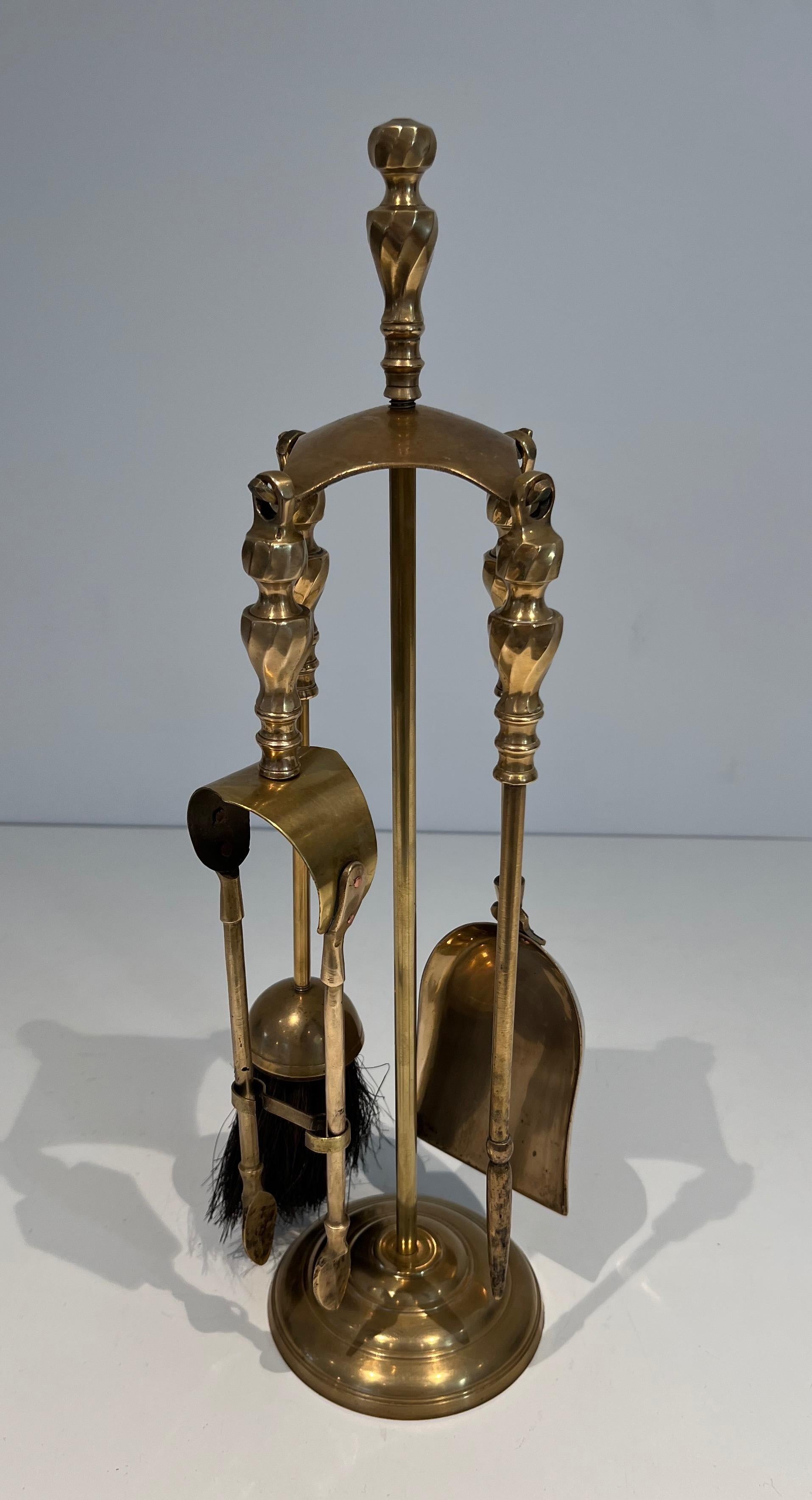 This very elegant neoclassical style fireplace tools is made of brass. This is a French work. Circa 1970