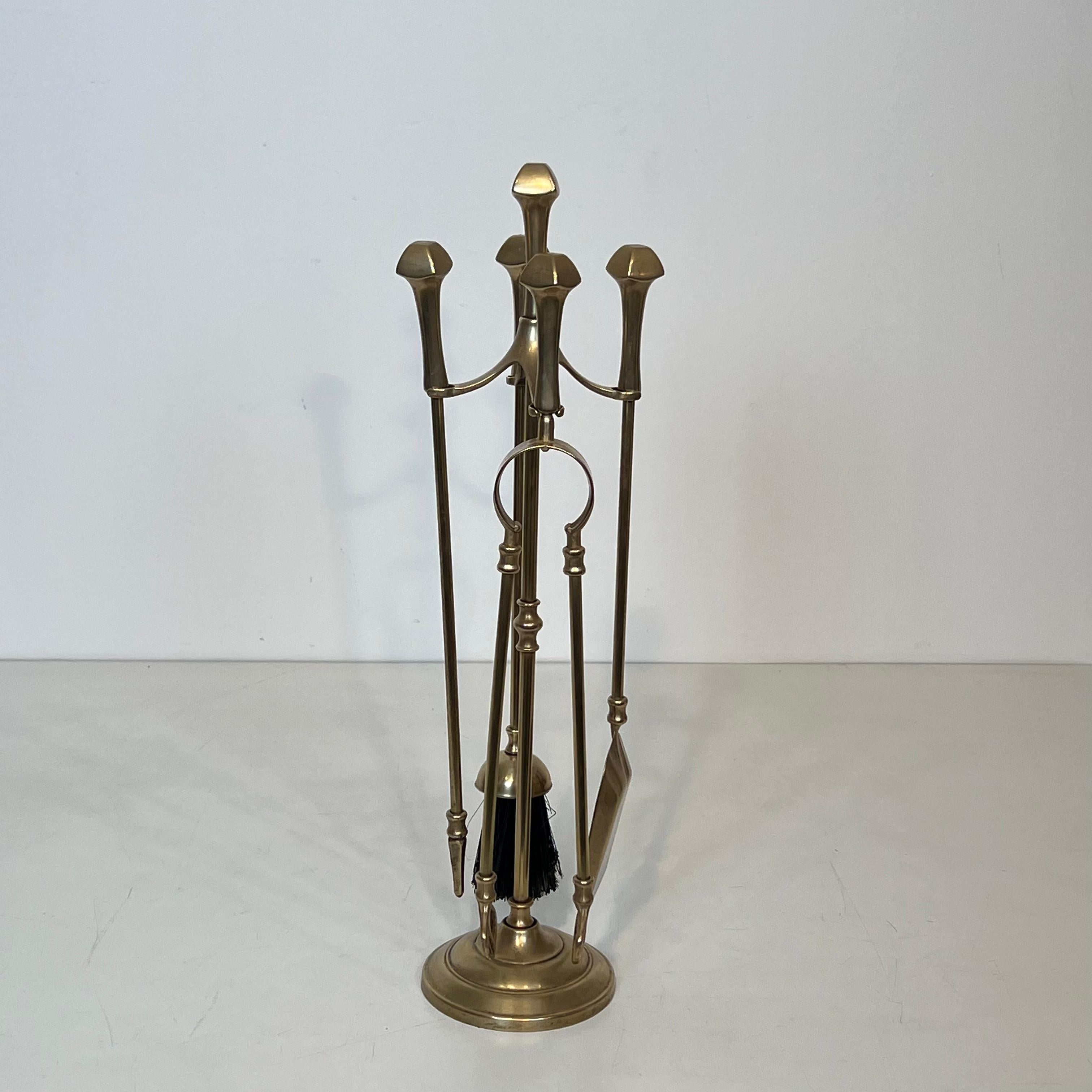 This nice and elegant neoclassical style fireplace tools is made of brass. This is a French work. Circa 1970
