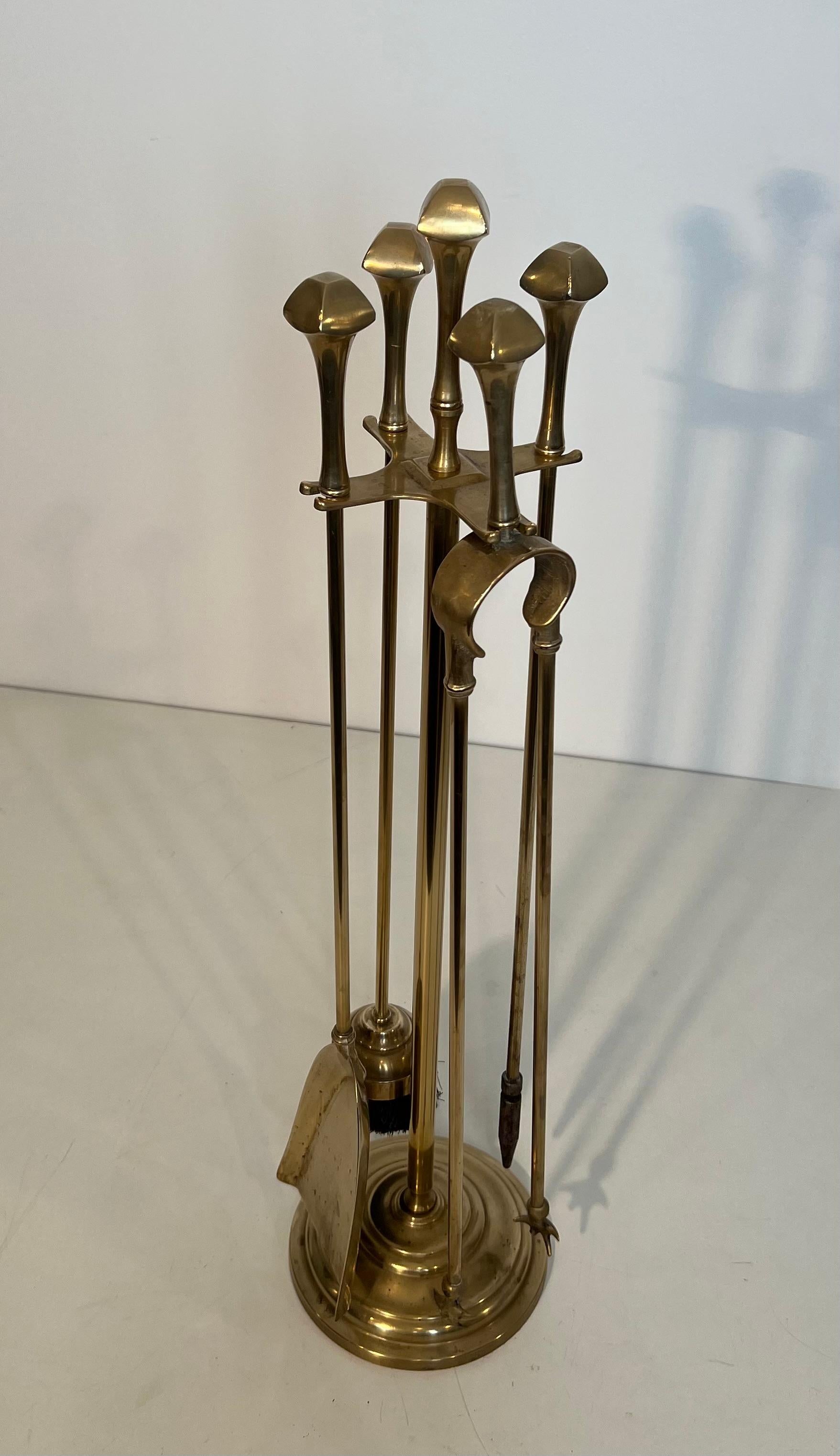 Questo simpatico strumento per caminetto in stile neoclassico è realizzato in ottone. Questa è un'opera francese. Circa 1970