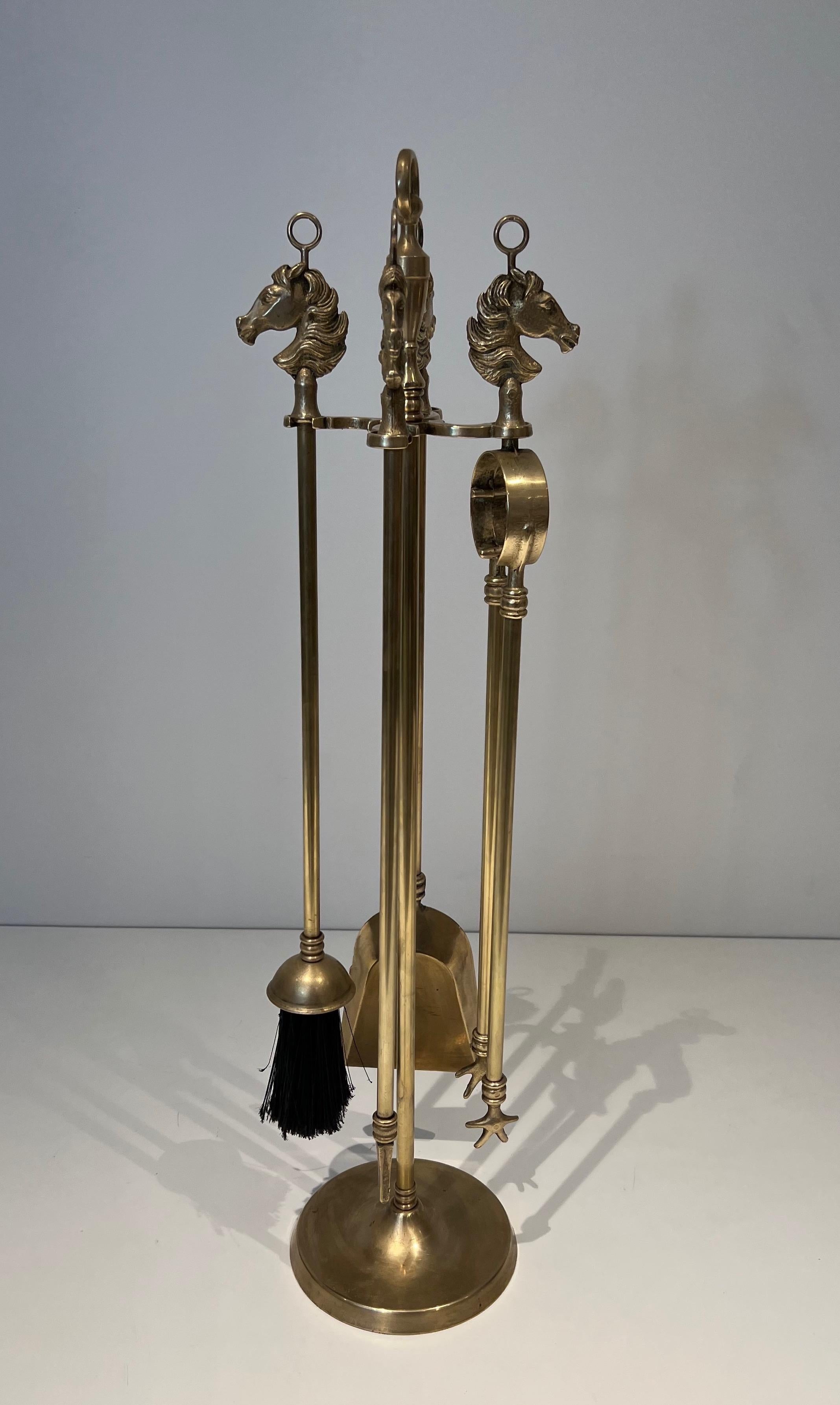 This nice and elegant neoclassical style horseheads fireplace tools is made of brass. This is a French work. Circa 1950