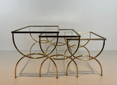 Neoclassical style brass nesting tables  with arcuate base. French work