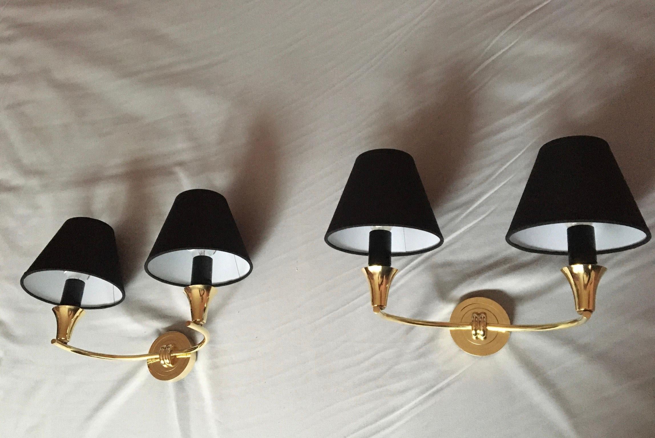 Beautiful pair of double arm in a very refined neoclassical style sconces of the 1950s in brass with black coton shades.

The pair is in excellent condition, electrical parts have been renewed and fit the US standards ( screw bulb holder, 40 watts
