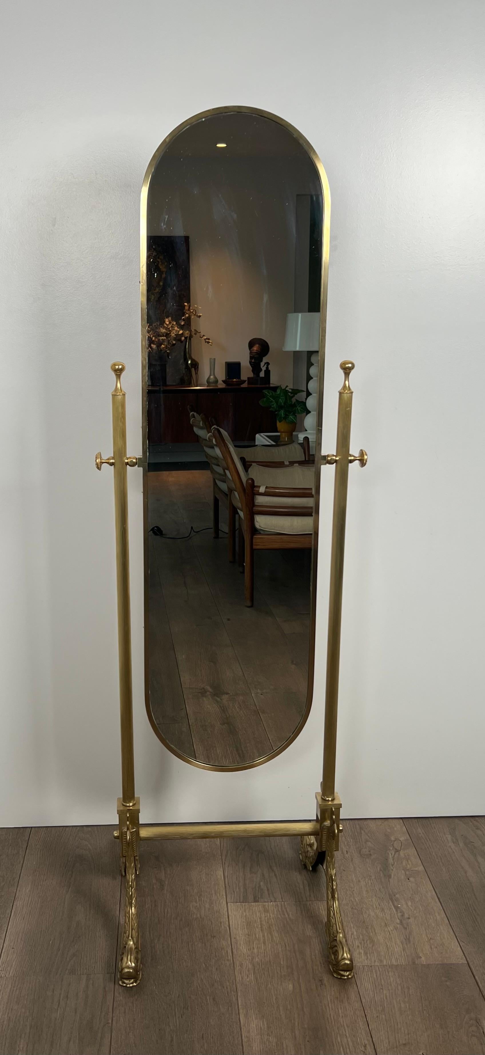 This neoclassical style swinging psyche mirror is made of brass with dolphins base. This is a French work by Maison Jansen. Circa 1940