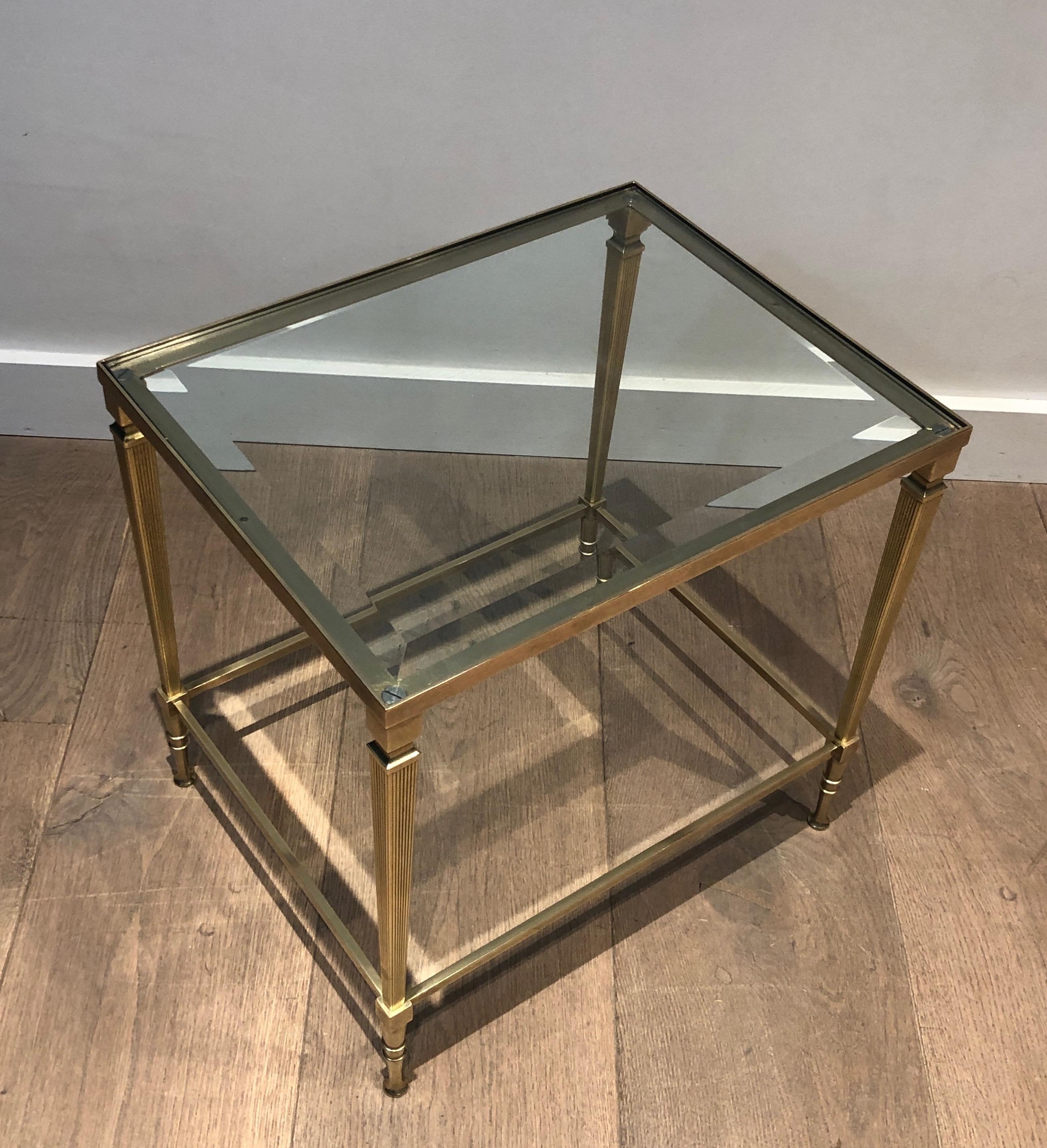 This neoclassical style side table is made of brass with fluted legs. This is a French work by Maison Jansen. Circa 1940
