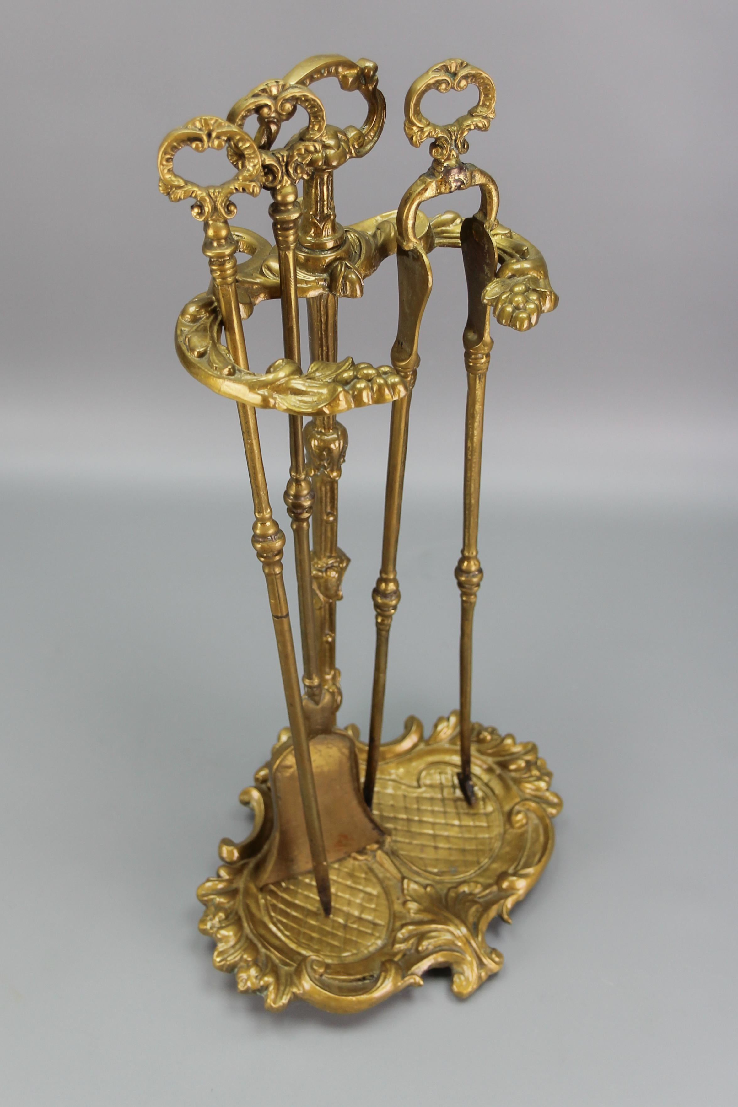 Neoclassical style fireplace tool set, made of bronze and brass, France, circa the 1950s.
A beautiful set of fireplace tools and their Stand made of bronze and brass. The base of the Stand is ornate with acanthus leaves and scrolls, and the