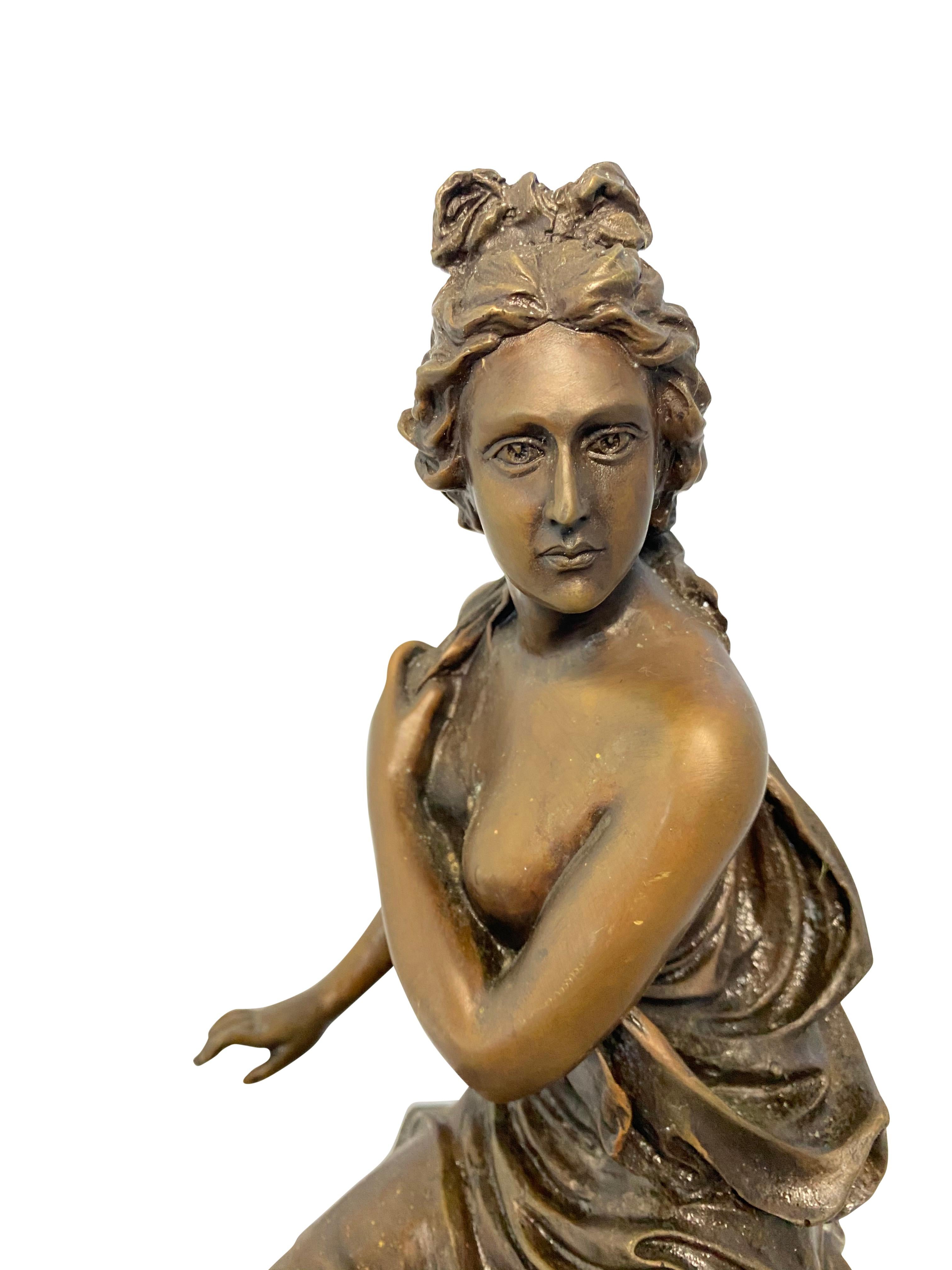 A neoclassical style bronze lady on detailed plinth base, 20th century. The styled sculpture of a striking, semi-nude woman on an exotic plinth. The lady features idealized Greek proportions and a dynamic energy. Excellent decoration for the