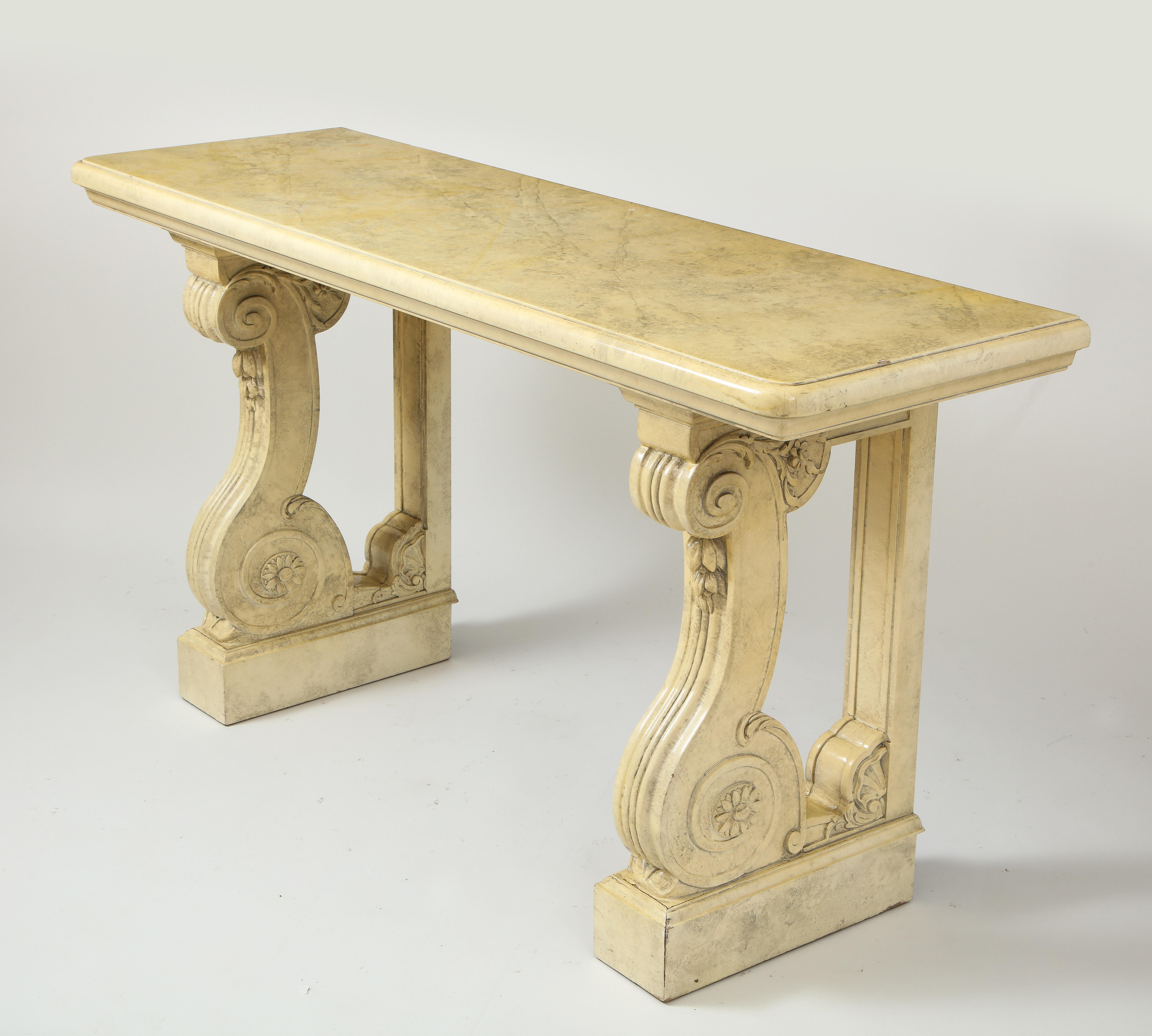Beautifully faux painted in a cream marble faux finish, the rectangular top raised on two volute form supports terminating in sunflower heads and enriched with foliate decoration.