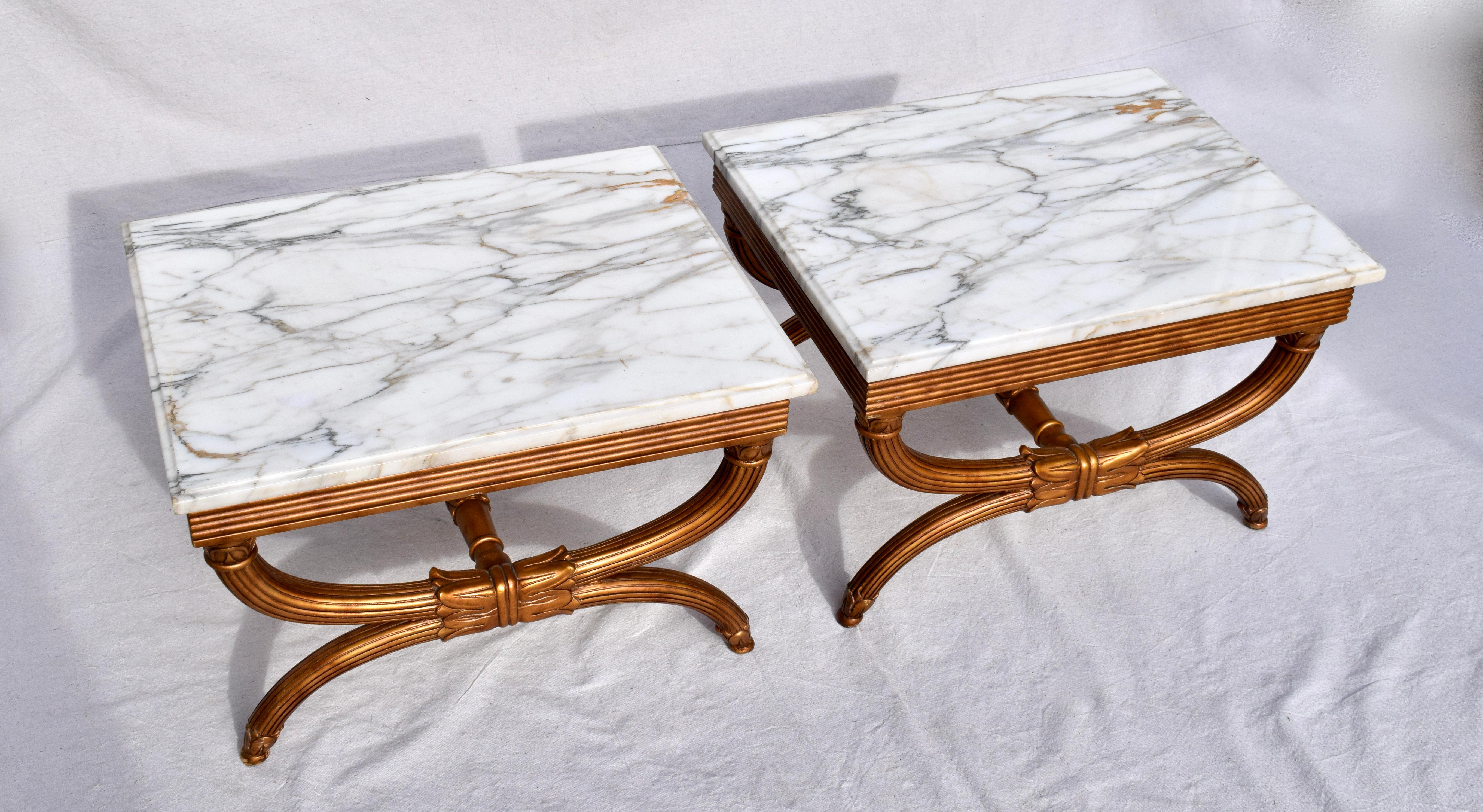 Elegant pair of gold Curule X form tables with stretchers & Carrara marble tops made in Italy; signed. Beautifully maintained original finish. Tops are removable.