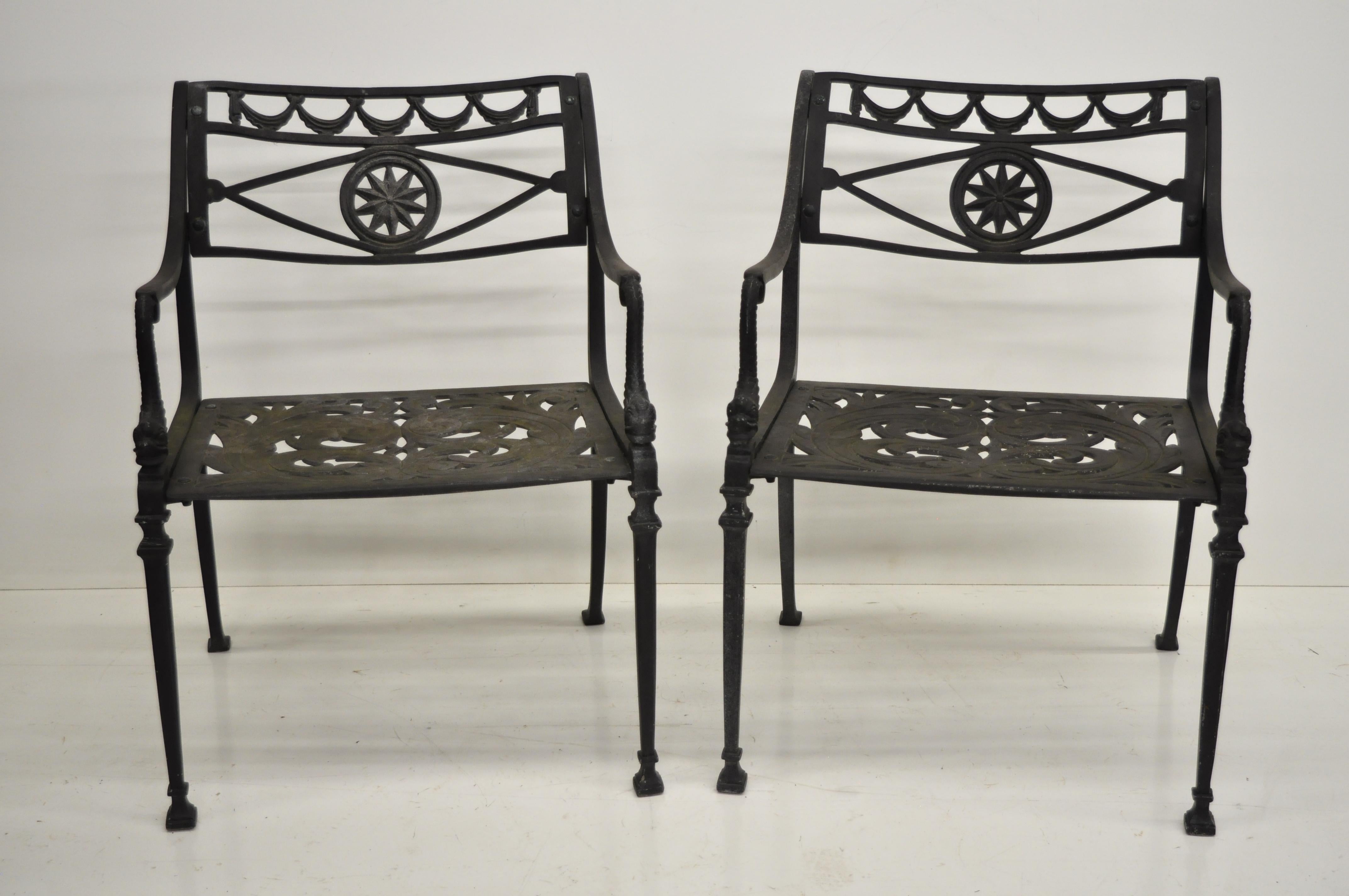 Pair of vintage neoclassical style dolphin armchairs in the neoclassical style. Unmarked but believed to be Molla. Item features pierced filigree design seat and star back, dolphin arm supports, heavy cast aluminium construction, quality