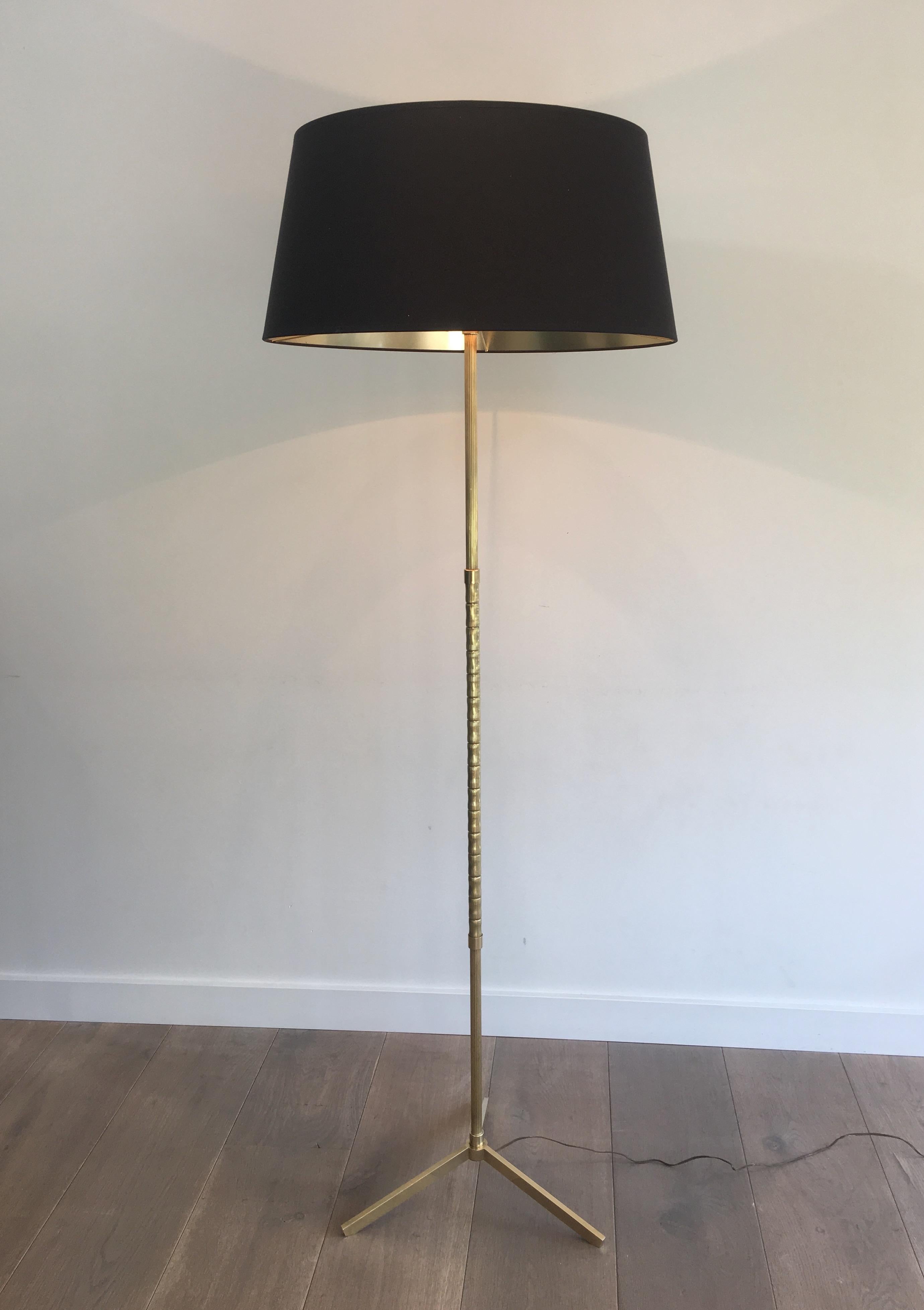 This neoclassical style floor lamp is all made of brass. This is a very nice work, imitating bamboo. The shade is made of black shintz, gilt inside. This lamp is in the style of famous French designer Maison Baguès, circa 1960.