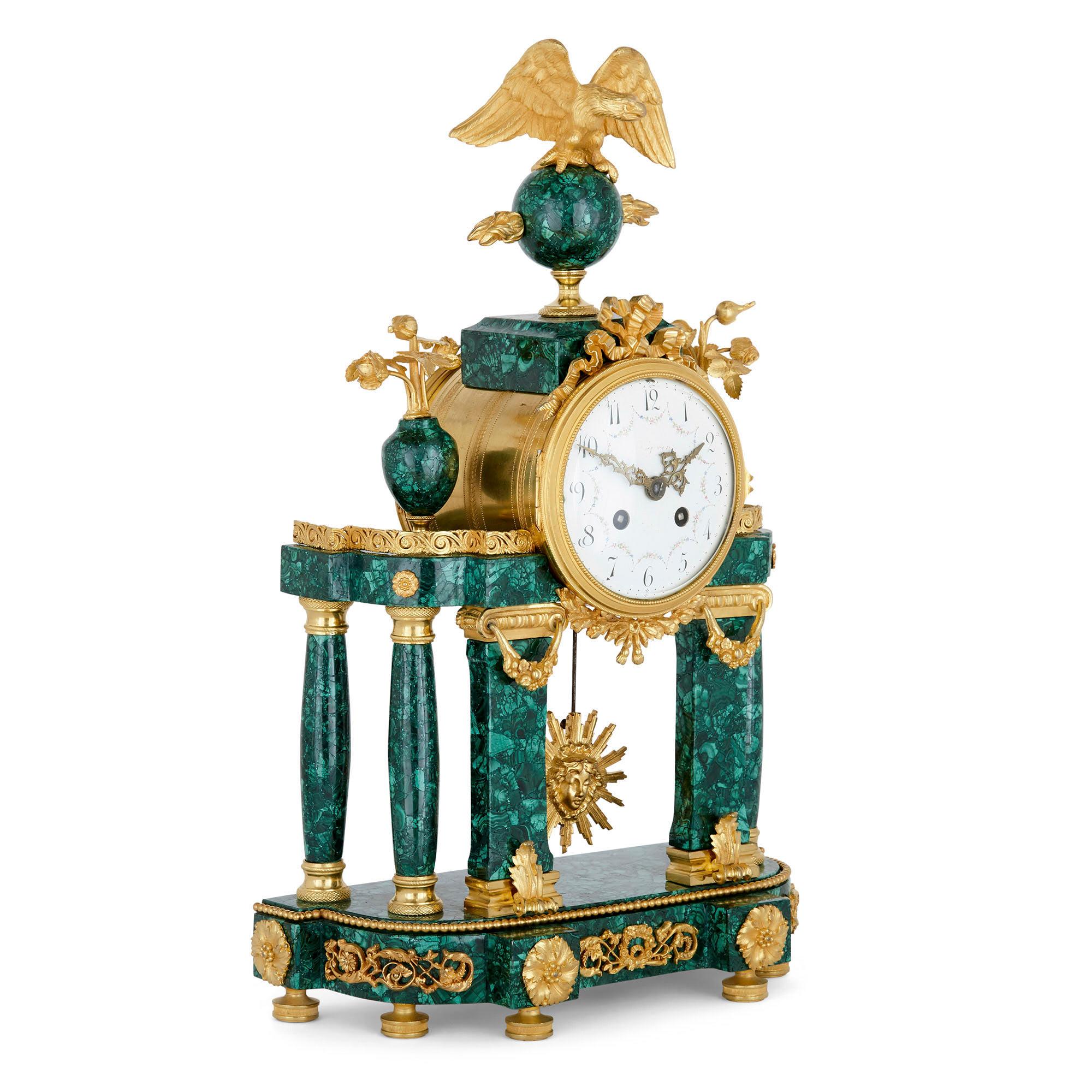 Neoclassical style French malachite and gilt bronze mantel clock
French, late 19th century
Dimensions: Height 48cm, width 30cm, depth 15cm

This neoclassical Louis XVI style mantel clock features a centrally placed circular enamel dial with