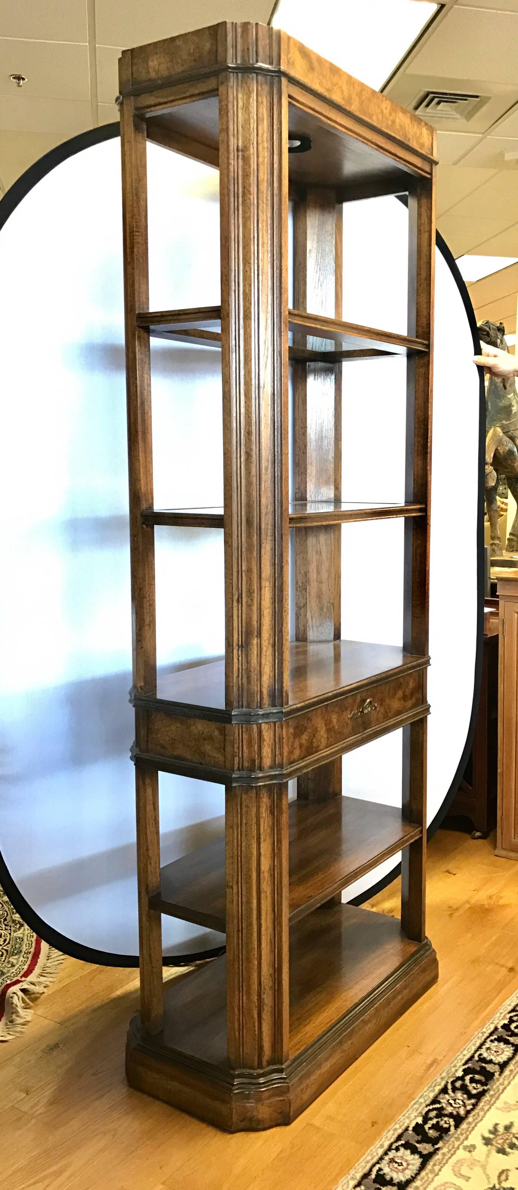 Elegant pair of matching fruitwood lighted étagères or bookcases with five shelves separated by one drawer. The two top shelves have glass inserts that are lit from above.