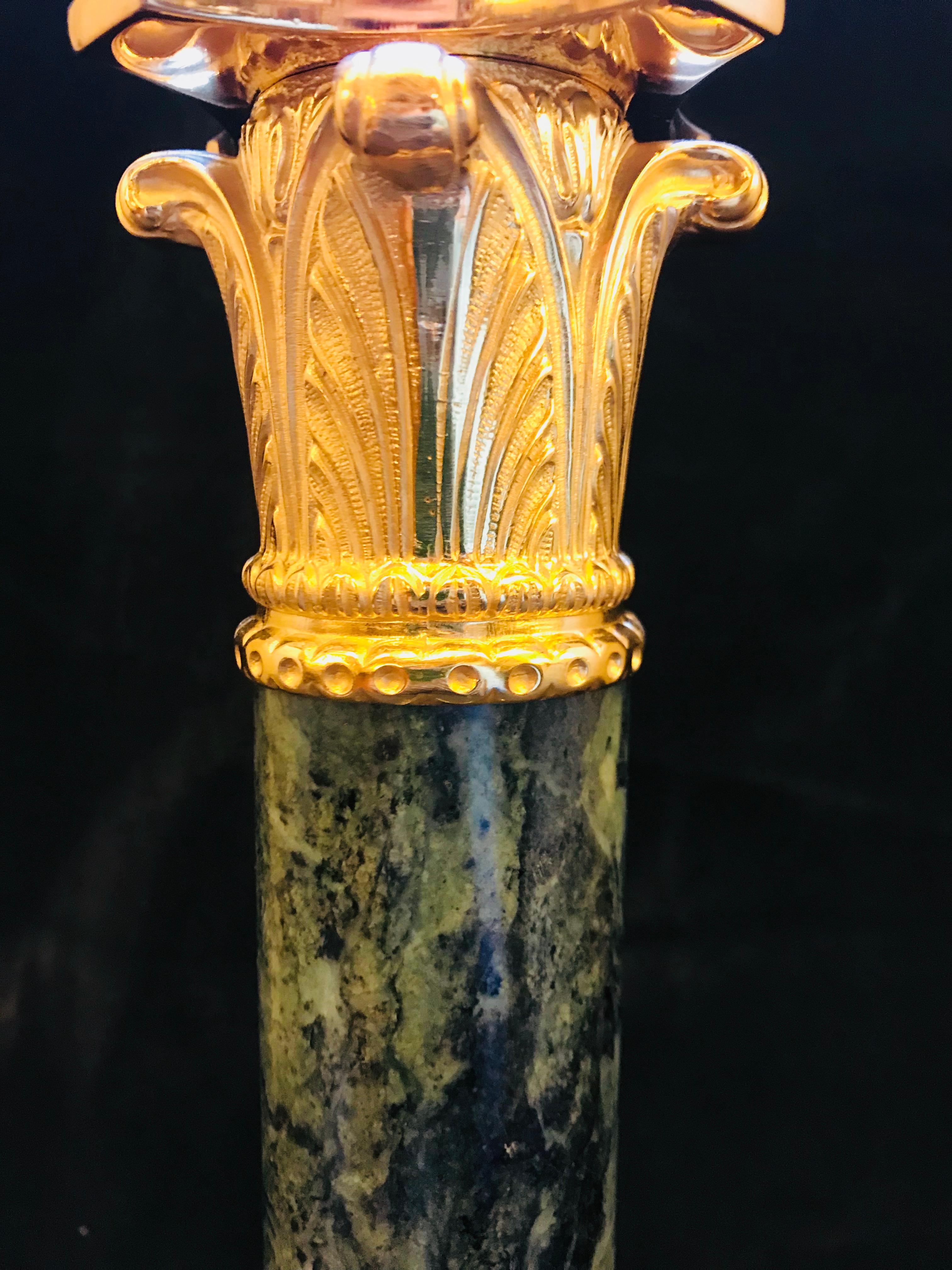 This elegant Neoclassical Style Gilt Bronze and Black Marble Lamp By Gherardo Degli Albizzi features high quality gilt bronze decoration such as the fully chiseled capital or the base with a decorative foliate motif. Marble column and circular base