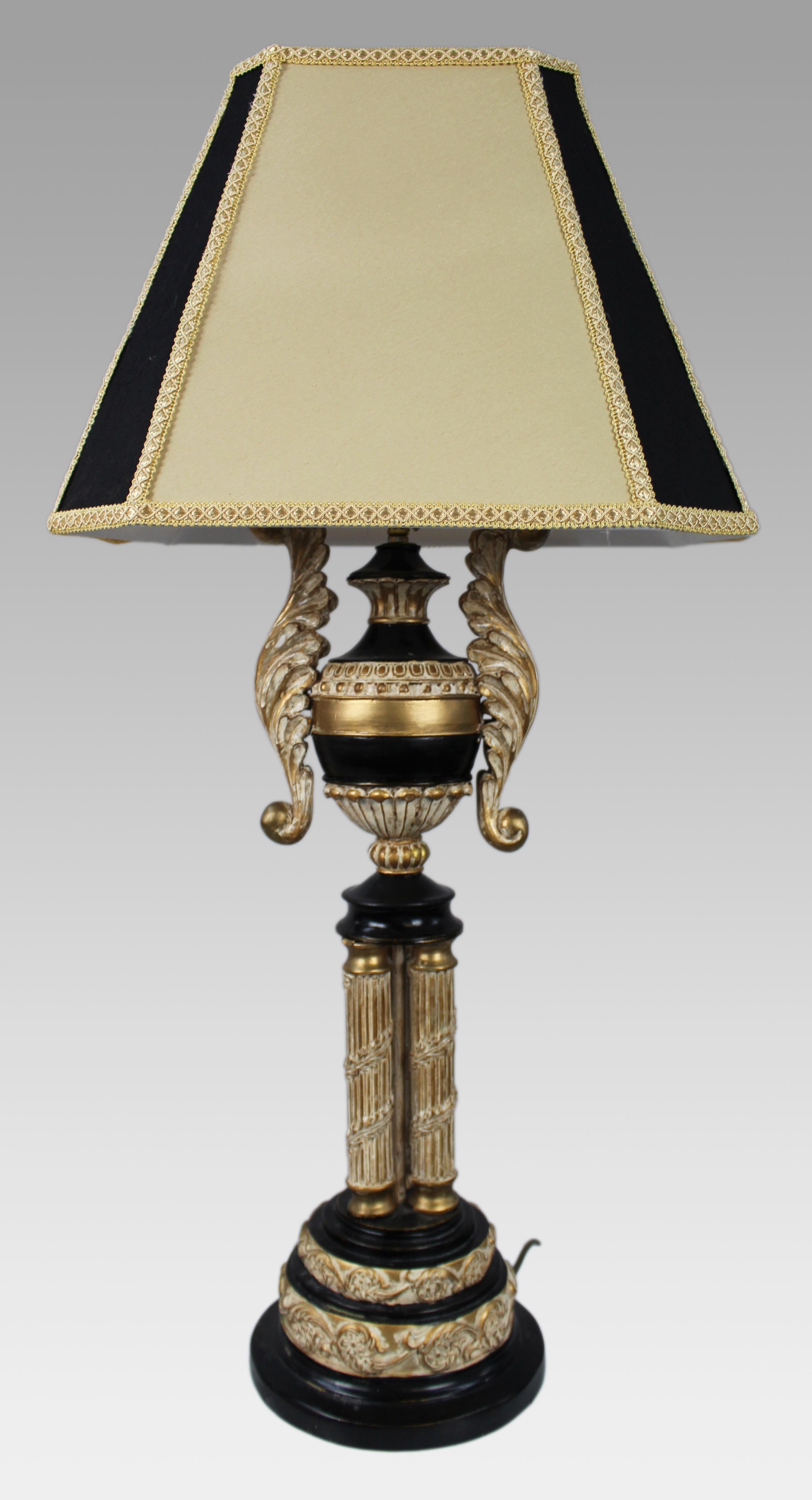 Neoclassical Style Table Lamp with Gilt and Ebonised Finish

A tall and decorative neoclassical revival table lamp, dating from the late 20th century.

Constructed from a combination of carved wood and composite materials, the lamp features an
