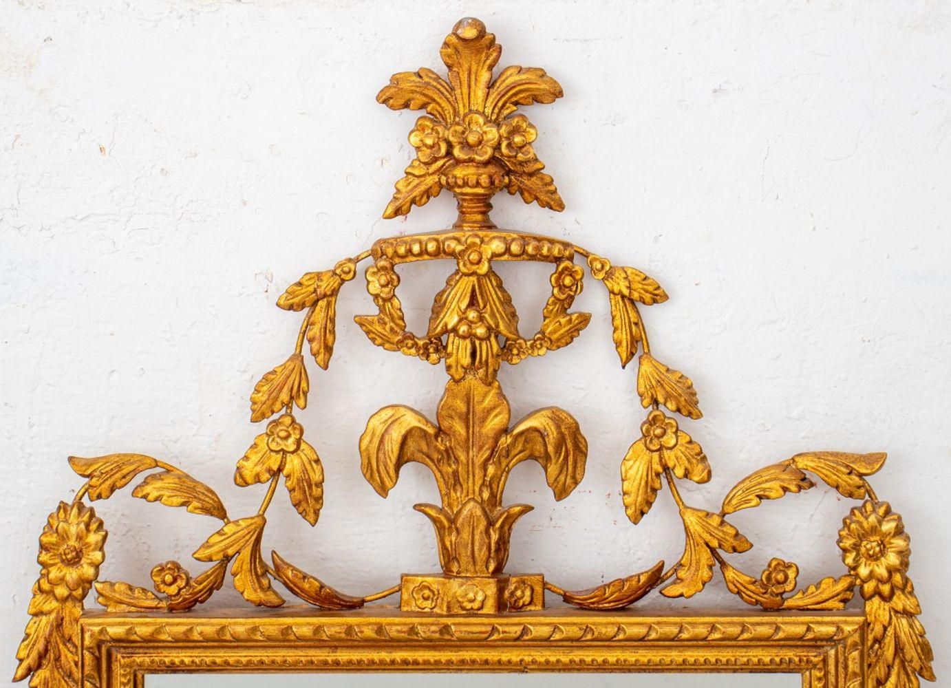 Neoclassical Style Giltwood Beveled Glass Mirror, carved with a floral design. 48.5