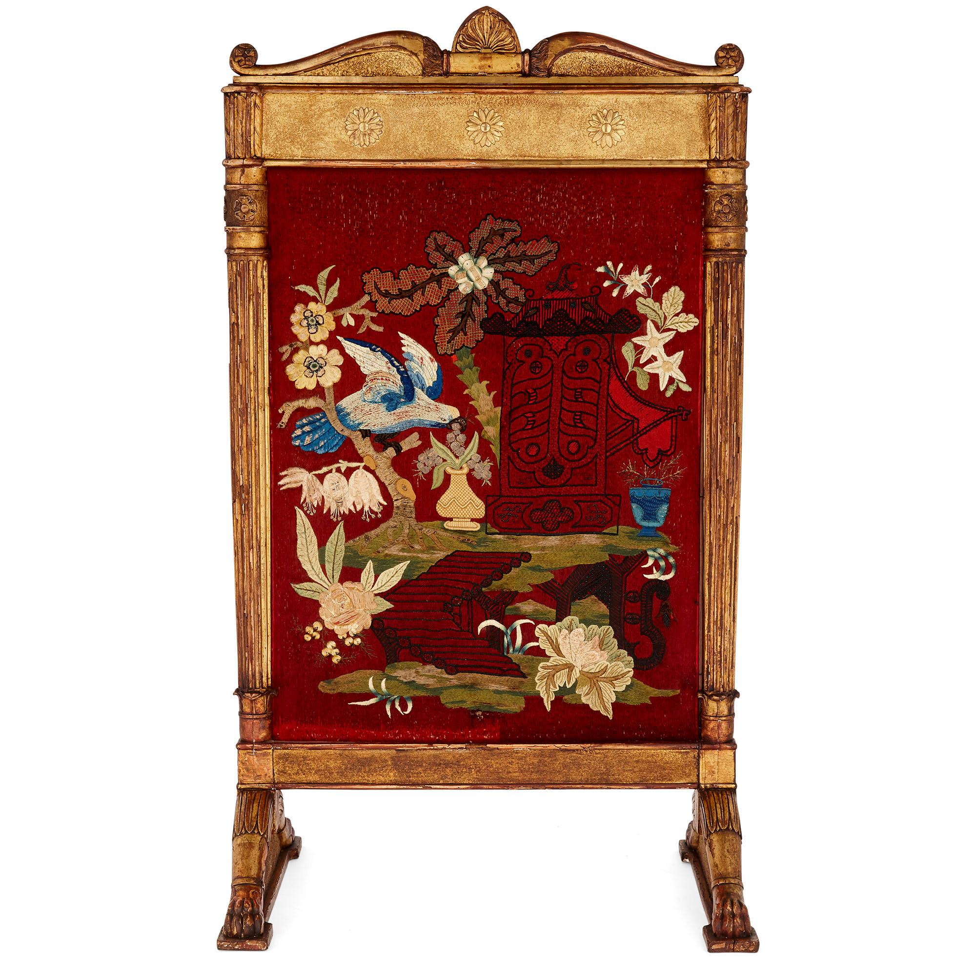 This firescreen features a beautifully embroidered central red-ground fabric panel, the embroidery portraying faintly Chinese-style motifs. The embroidered panel is held within a giltwood frame, the design of which is distinctly neoclassical—the