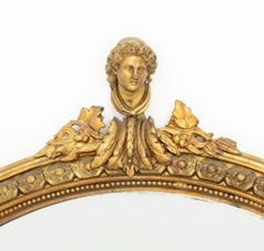 Neoclassical Style Giltwood Framed Oval Mirror with Figurative Crest