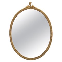 Neoclassical Style Giltwood Framed Oval Mirror with Figurative Crest
