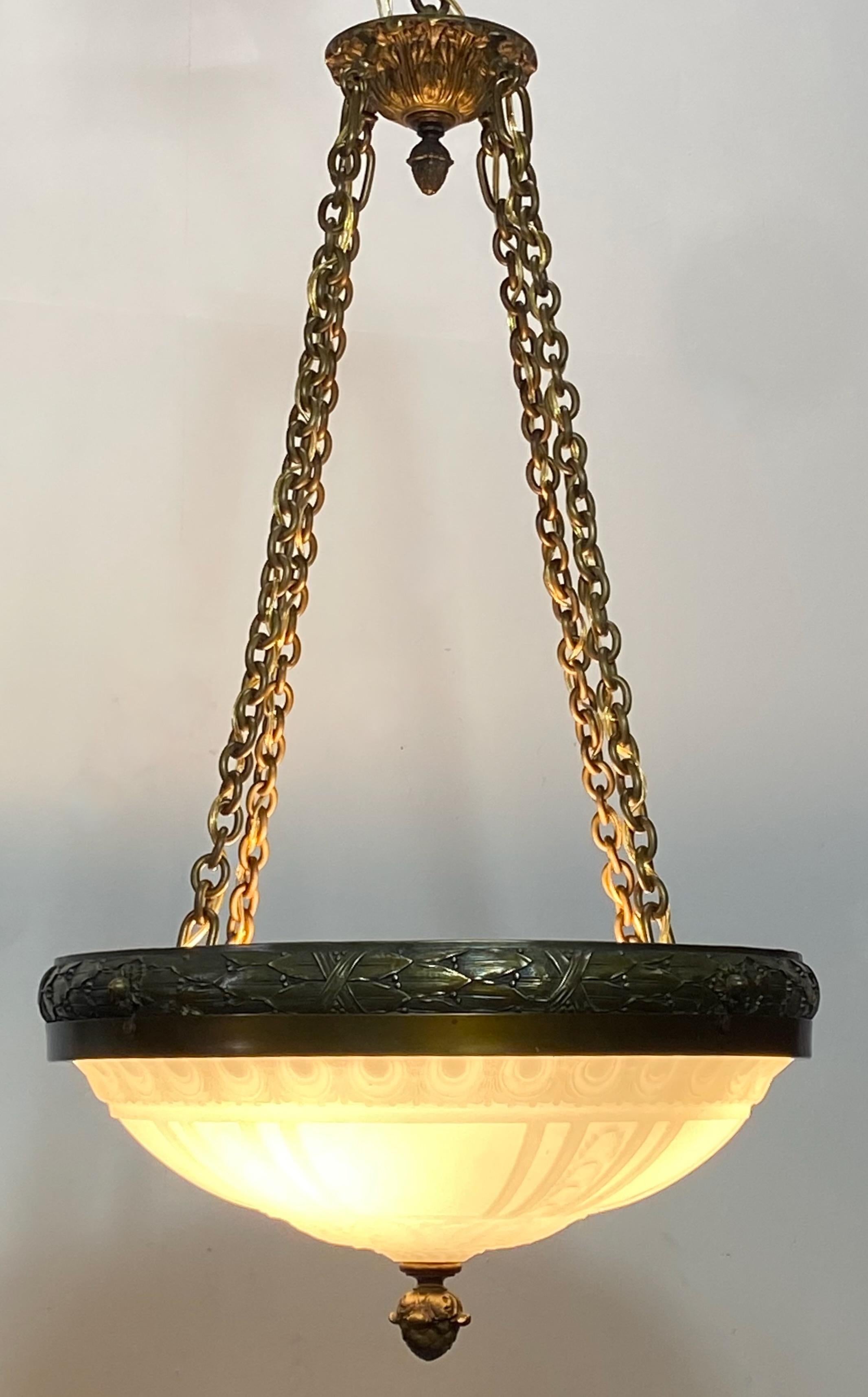 An exceptional neoclassical style pendant ceiling light fixture.
Calcite cast glass bowl with wonderfully detailed brass outer ring, brass hardware and acorn finial.
American, early 20th century, circa 1915.
Restored and rewired.
Beautiful