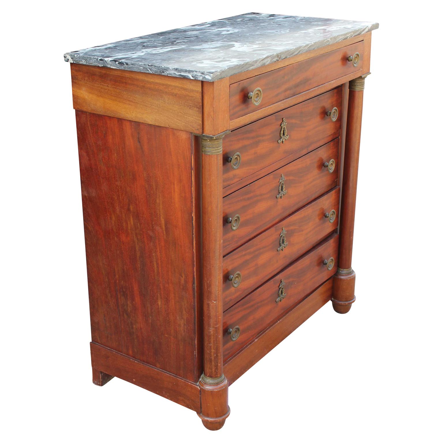 Lovely neoclassical five drawer mahogany chest of drawers / tall dresser with a grey marble top and brass hardware.