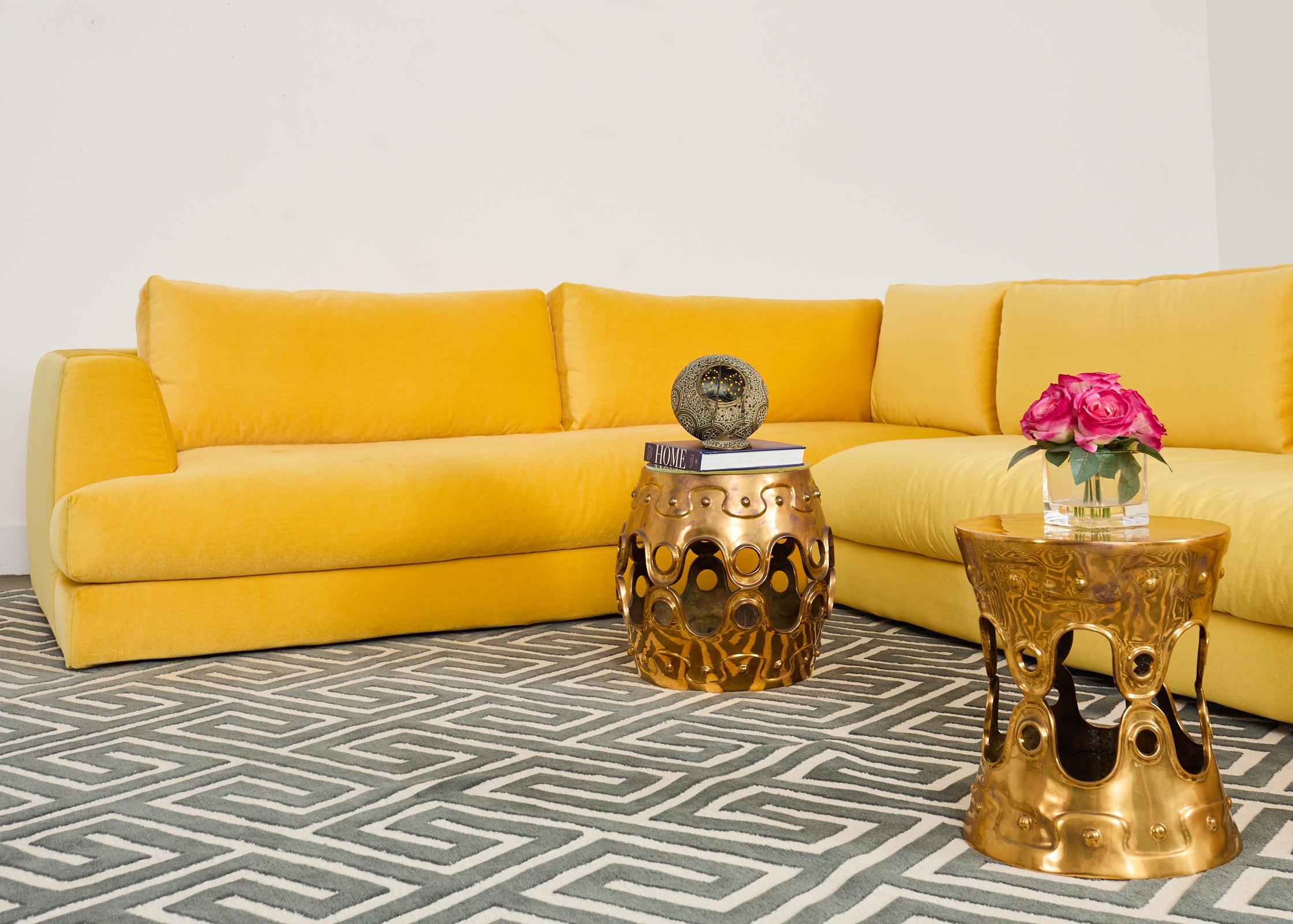 Stunning geometric hand-woven carpet designed by Suzanne Sharp for The Rug Company. The rug features a large greek key motif repeating pattern in a slate gray tone over a white background. The symmetrical key pattern is slightly twisted into a
